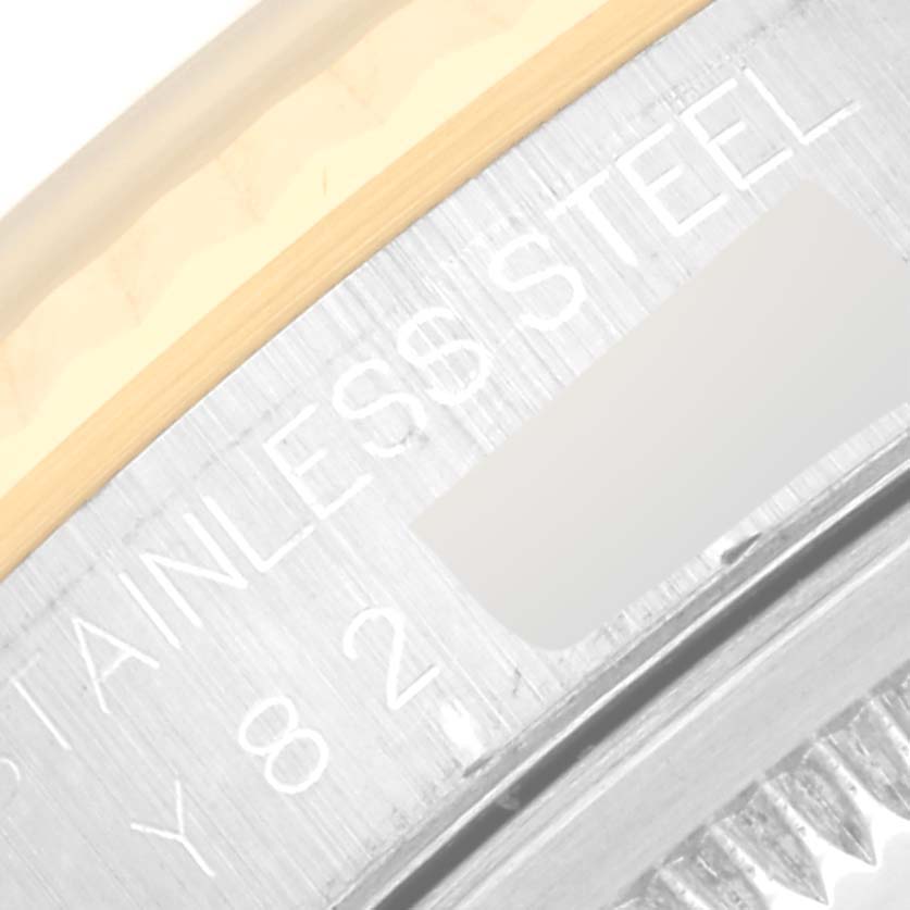 An extreme close-up of the side of the bezel, showing the "STAINLESS STEEL" inscription on the Rolex Datejust 16233 Men's Steel and Gold (two tone) Silver Dial 16233 Men's Steel and Gold (two tone) Silver Dial model.