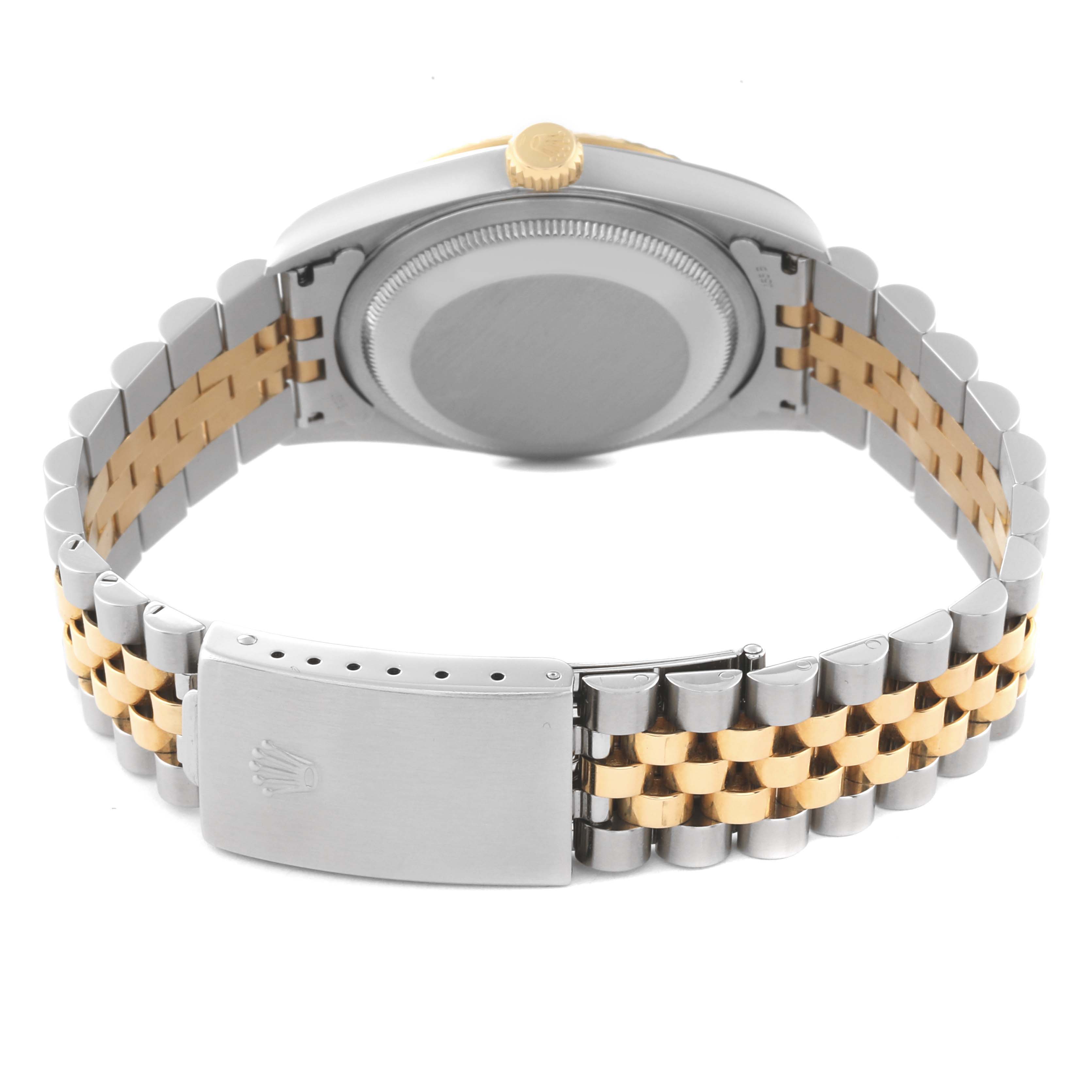 This image shows the back and bracelet of a Rolex Datejust 16233 Men's Steel and Gold (two tone) Silver Dial 16233 Men's Steel and Gold (two tone) Silver Dial watch from an angle focusing on the clasp and case back.