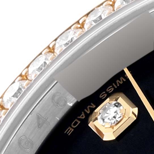This close-up image shows the bezel with diamonds and part of the dial of a Rolex Datejust 116243 Men's Steel and Gold (two tone) Black Dial 116243 Men's Steel and Gold (two tone) Black Dial watch.