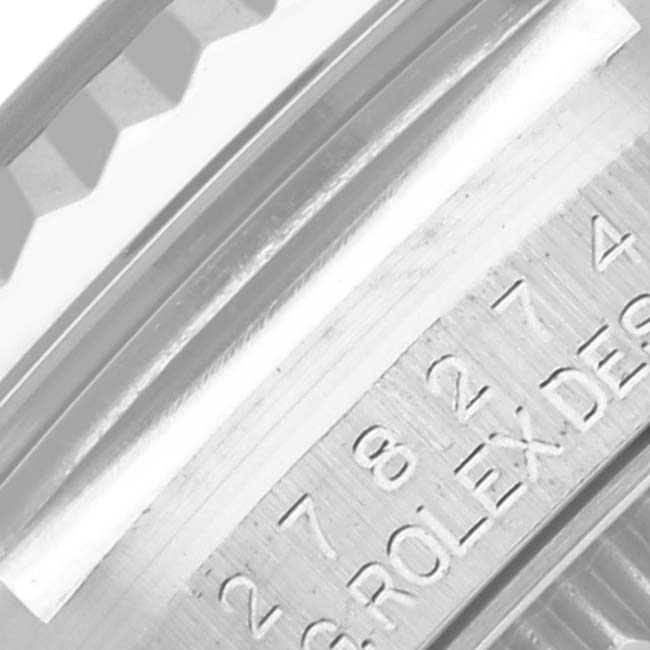 This close-up image shows the engraved serial number on the side of the Rolex Mid-Size 278274 Women's Stainless Steel Silver Dial 278274 Women's Stainless Steel Silver Dial watch case.