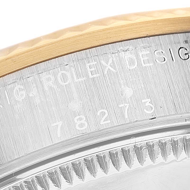 The image shows a close-up angle of the bezel and engraved serial number on a Mid-Size Rolex watch.