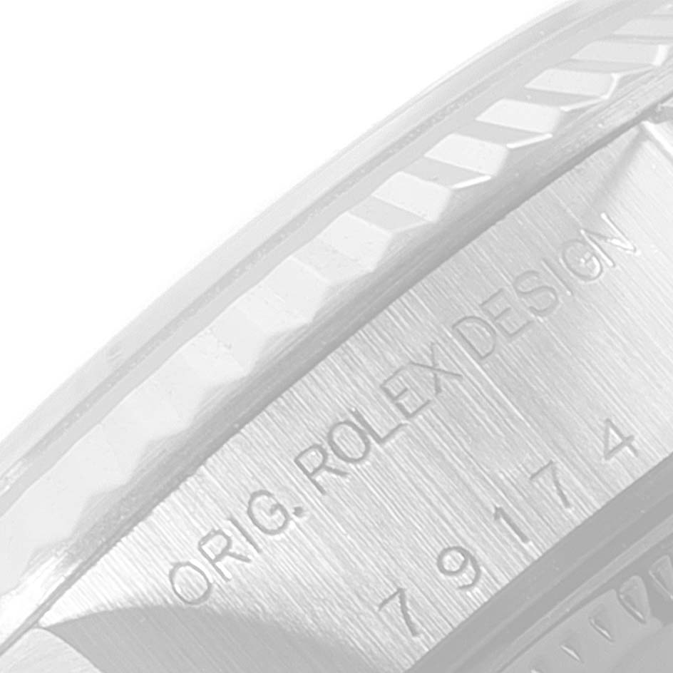 This image shows a close-up of the bezel and engraved case design details of a Rolex Datejust 79174 Women's Stainless Steel Black Dial 79174 Women's Stainless Steel Black Dial watch.