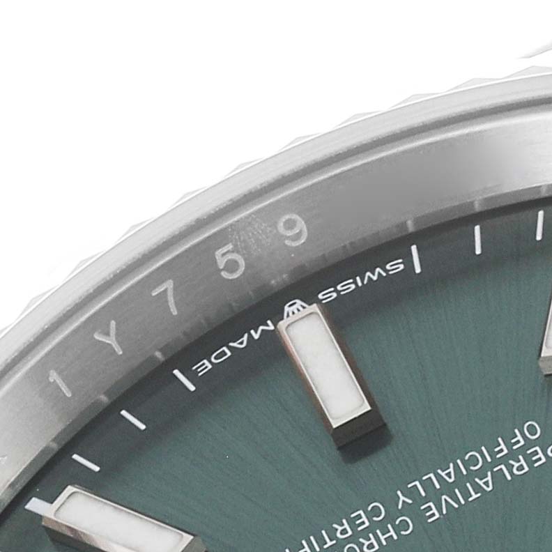 Close-up of the Datejust Rolex watch shows part of the dial, indices, and "Swiss Made" text, featuring the bezel's edge.