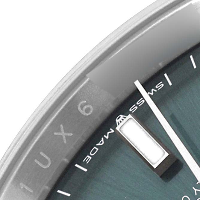 This image shows a close-up of the dial and part of the bezel of a Rolex Datejust 126234 Men's Stainless Steel Green Dial 126234 Men's Stainless Steel Green Dial watch.