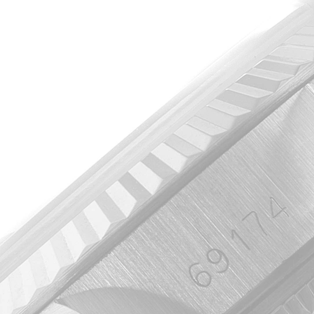 The image shows a close-up of the fluted bezel and case side of a Rolex Datejust 69174 Women
s Stainless Steel Silver Dial 69174 Women
s Stainless Steel Silver Dial with the model number clearly visible.