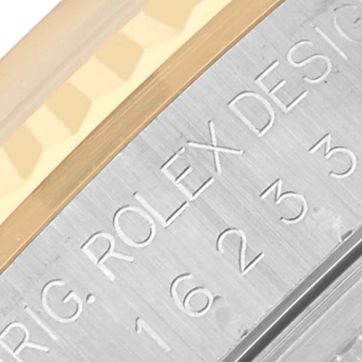 The image shows a close-up of the bezel and engraved part of the casing of a Rolex Datejust 16233 Men's Steel and Gold (two tone) Black Dial 16233 Men's Steel and Gold (two tone) Black Dial watch.