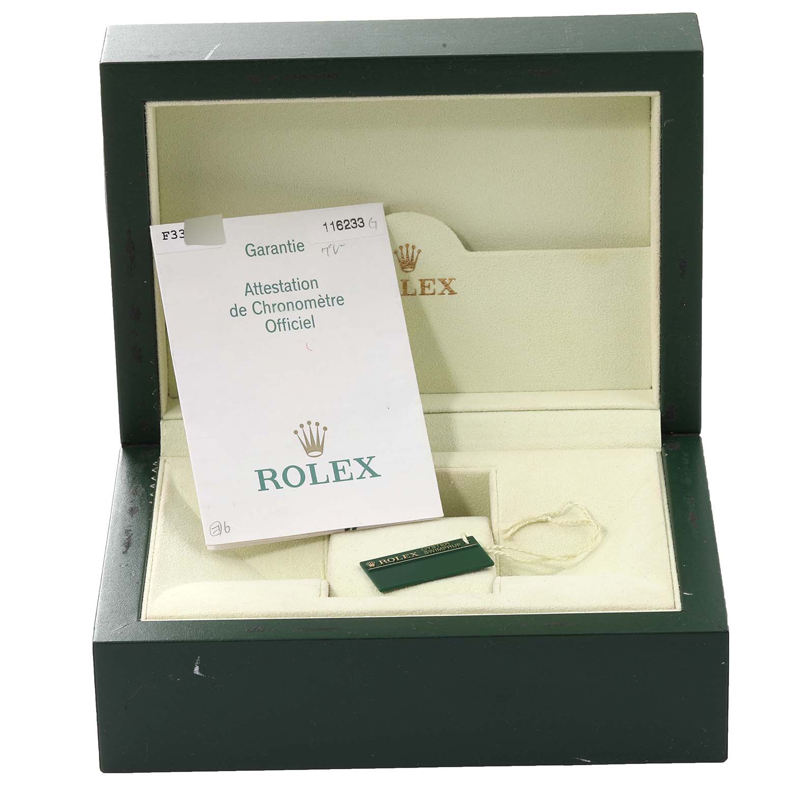 This image shows an open Rolex Datejust 116233 Men's Steel and Gold (two tone) Silver Dial 116233 Men's Steel and Gold (two tone) Silver Dial watch box containing official paperwork and a green tag.