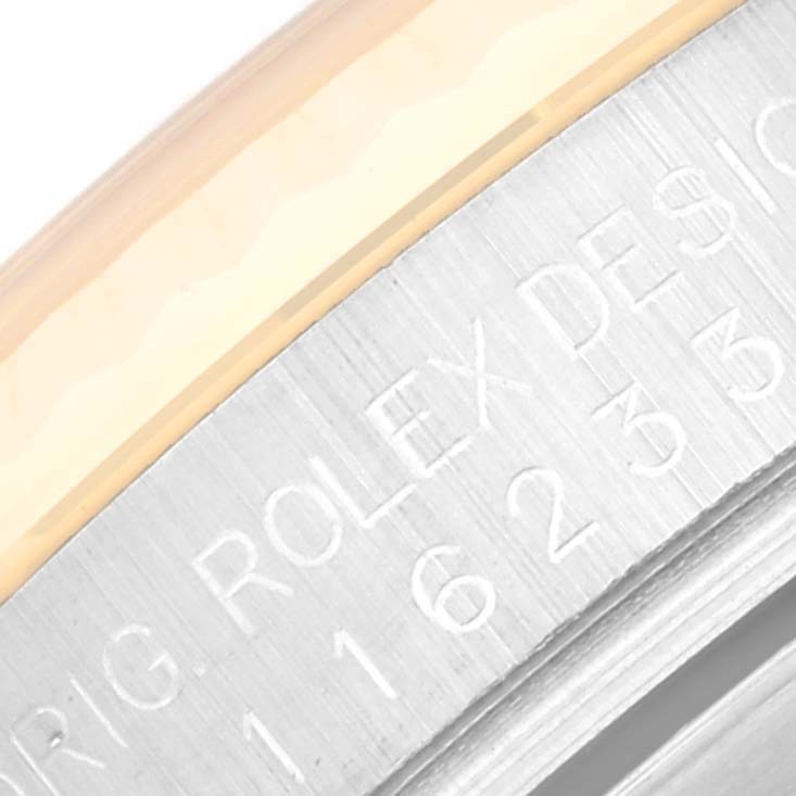 This close-up image shows the side engraving on the bezel of a Rolex Datejust 116233 Men's Steel and Gold (two tone) Silver Dial 116233 Men's Steel and Gold (two tone) Silver Dial watch.