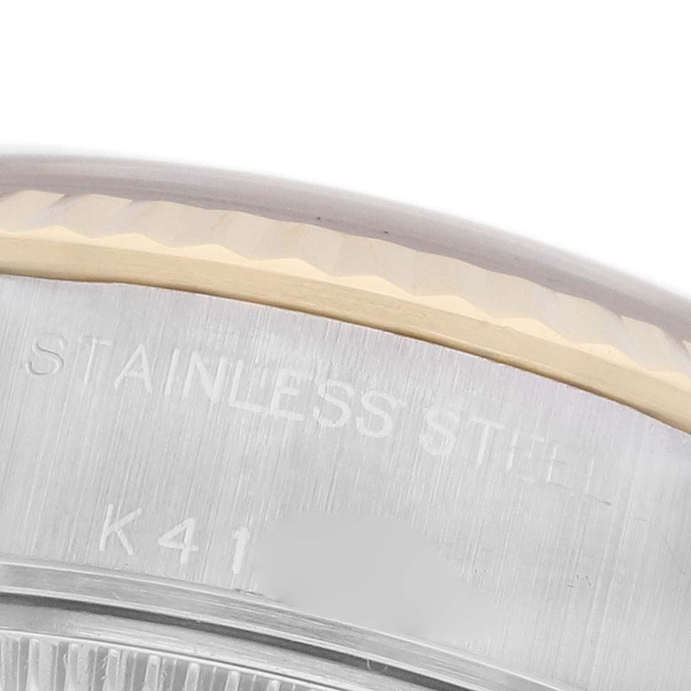 The image shows the edge of the Rolex Datejust 79173 Women's Steel and Gold (two tone) Champagne Dial 79173 Women's Steel and Gold (two tone) Champagne Dial case back, highlighting the stainless steel material and bezel detail.
