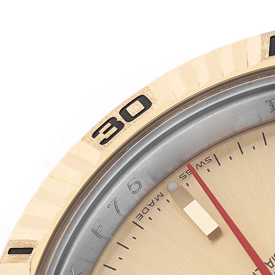 The Rolex Turn-o-Graph 116263 Men's Steel and Gold (two tone) Champagne Dial watch is shown at a close-up angle, highlighting the bezel and part of the dial.
