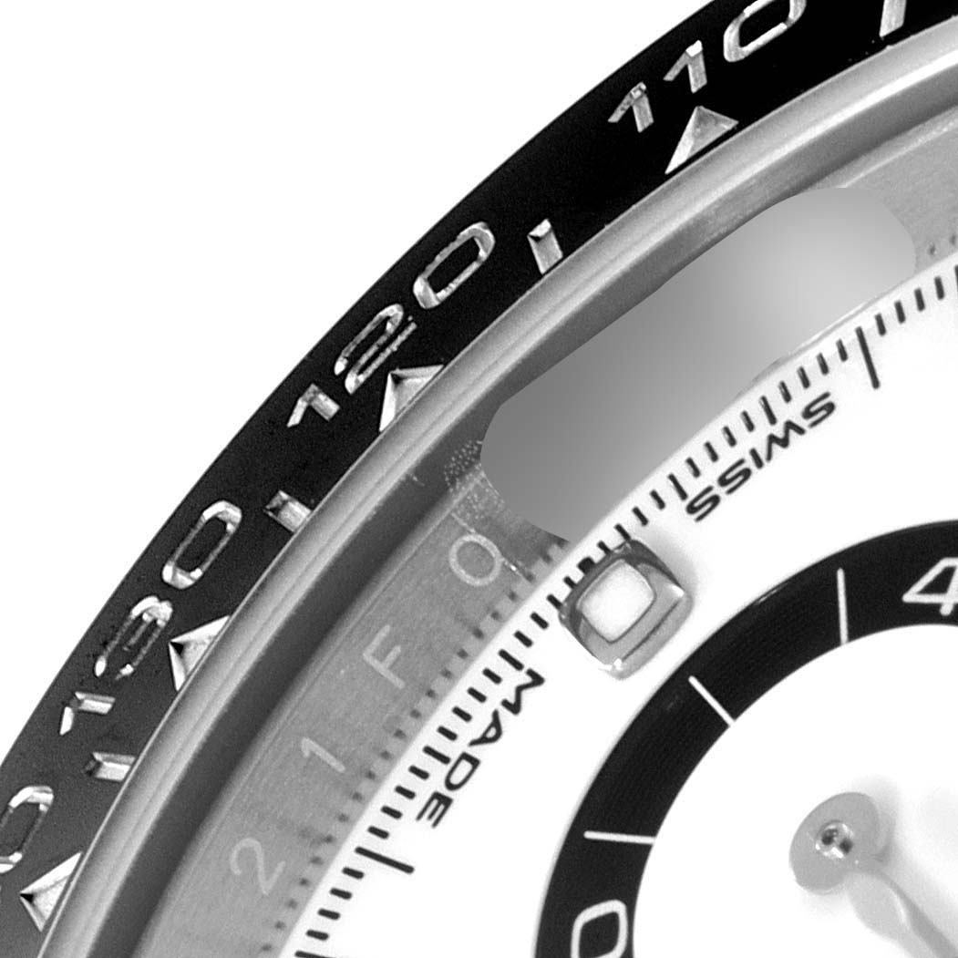 This close-up image shows the bezel and part of the dial of a Rolex Daytona 116500 Men's Stainless Steel White Dial 116500 Men's Stainless Steel White Dial watch.