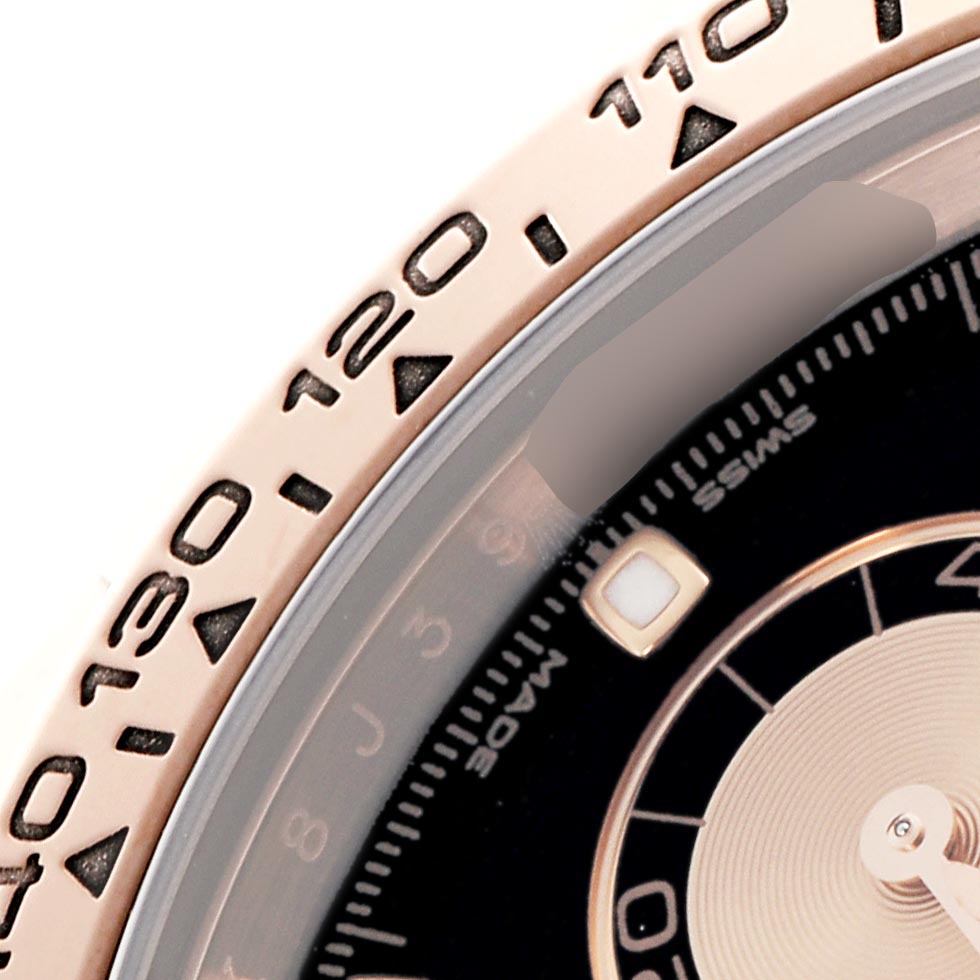 The image shows a partial view of a Rolex Daytona 116505 Men's Rose Gold Black Dial 116505 Men's Rose Gold Black Dial, focusing on the bezel with tachymetric scale and part of the dial.