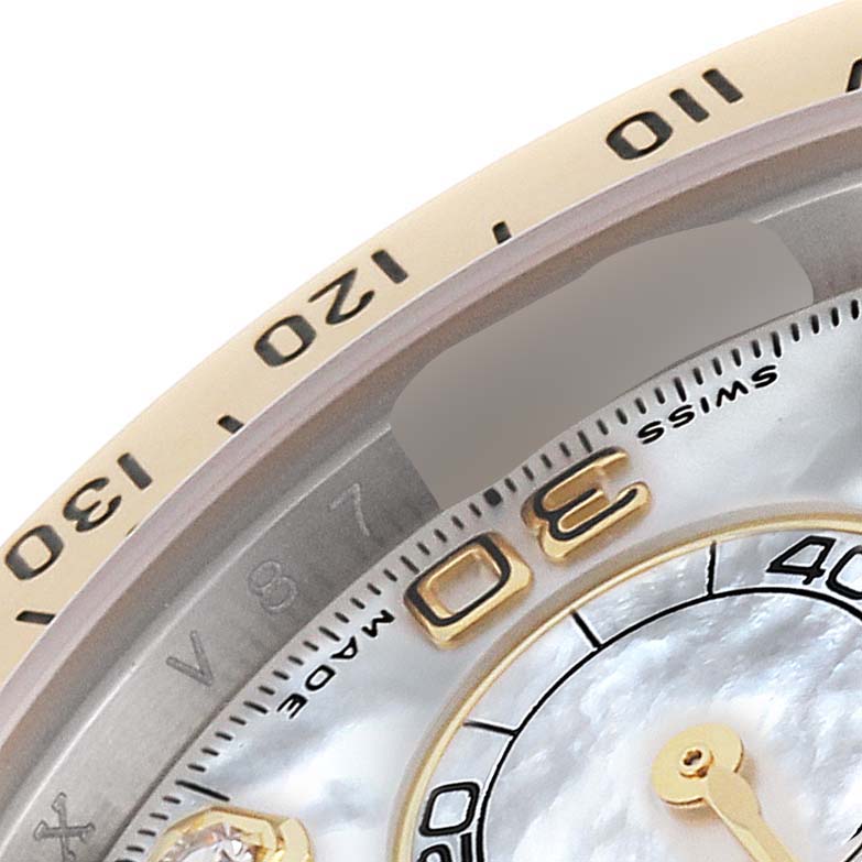 The image shows a close-up of the upper-left bezel and dial of a Rolex Daytona 116523 Men's Steel and Gold (two tone) Mother of Pearl Dial 116523 Men's Steel and Gold (two tone) Mother of Pearl Dial watch, displaying numbers and part of the sub-dial.