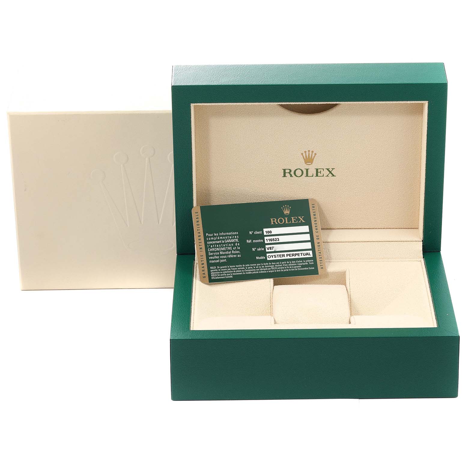 The image shows a green and cream Rolex box for a Daytona model, along with the official card.