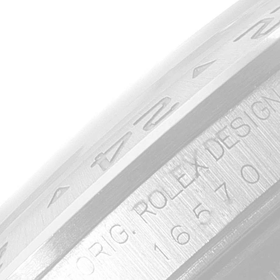 The image shows a close-up of the bezel edge and engraved serial number of a Rolex Explorer 16570 Men's Stainless Steel Black Dial 16570 Men's Stainless Steel Black Dial watch.