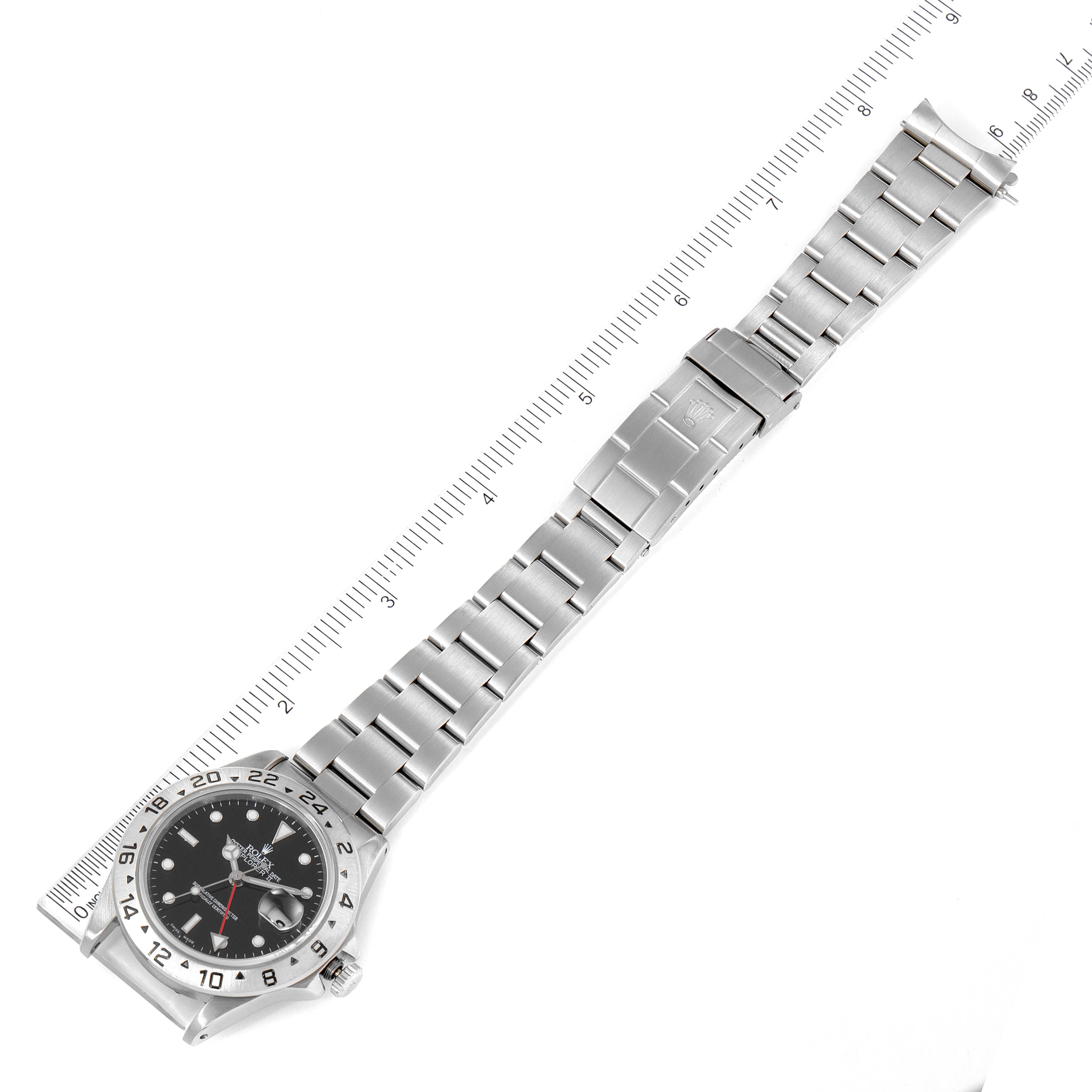 The image shows a Rolex Explorer 16570 Men's Stainless Steel Black Dial 16570 Men's Stainless Steel Black Dial watch laid flat, with its bracelet extended alongside a ruler for measurement.