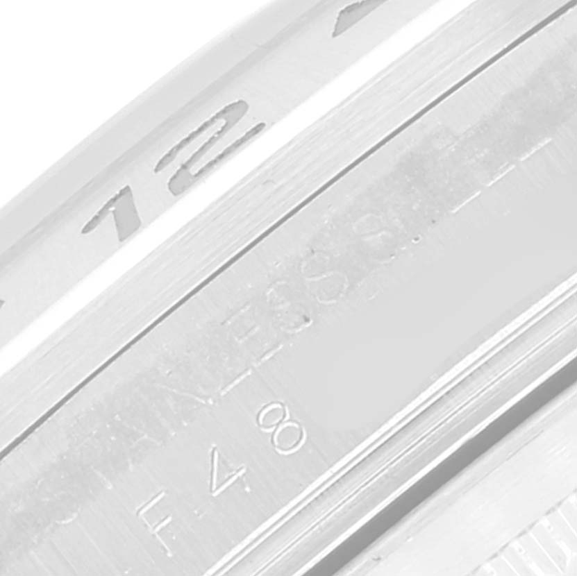 This close-up image shows the edge and part of the engraving on a Rolex Explorer 16570 Men
s Stainless Steel Black Dial 16570 Men
s Stainless Steel Black Dial watch
s bezel and casing.