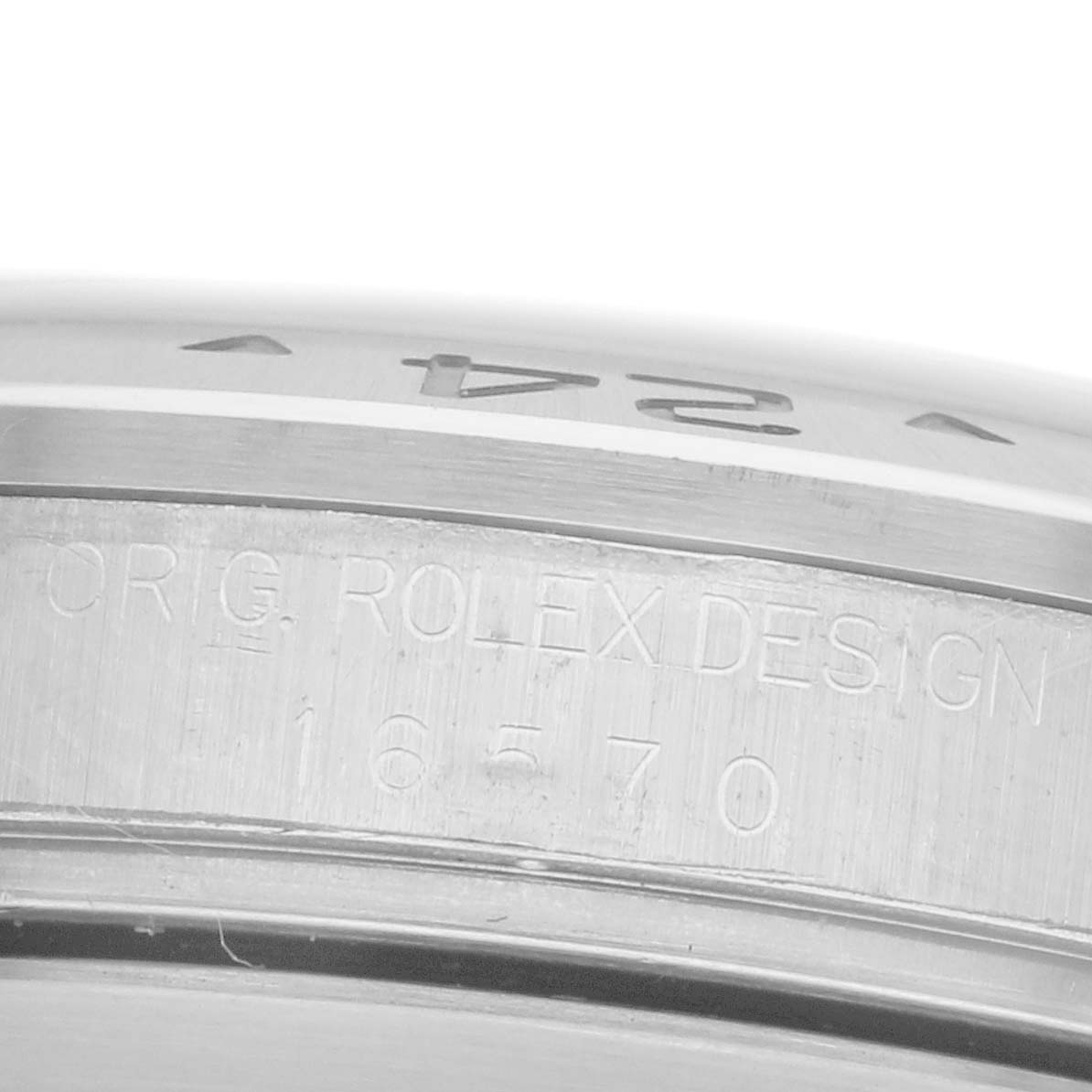 The image shows a close-up of the engraved side of a Rolex Explorer 16570 Men's Stainless Steel White Dial 16570 Men's Stainless Steel White Dial watch, focusing on the model number "16570" and "ORIG. ROLEX DESIGN."