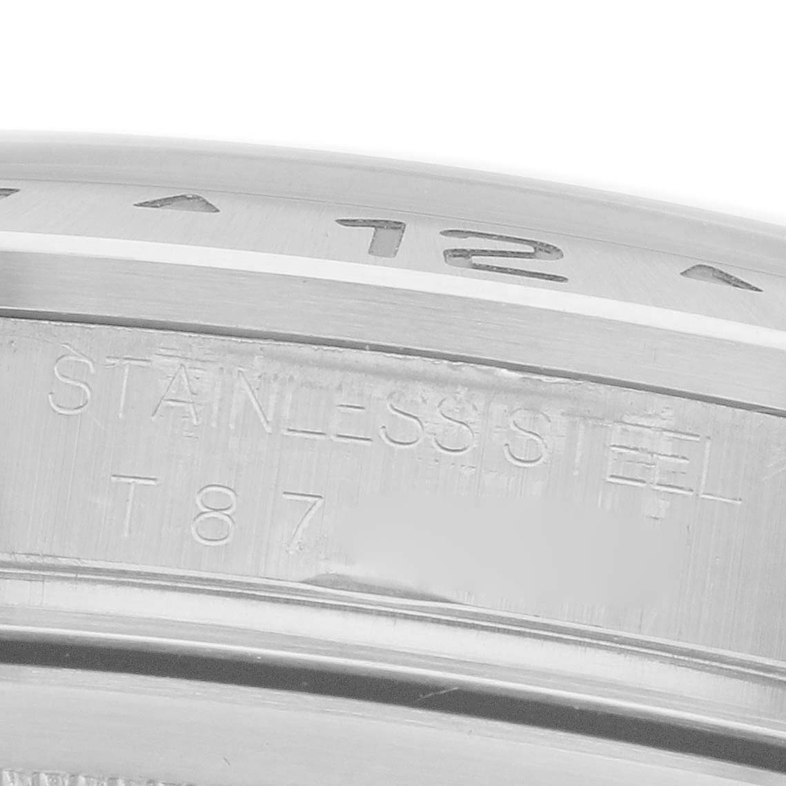 The image shows a close-up of the engraved stainless steel inner bezel of the Rolex Explorer 16570 Men's Stainless Steel White Dial 16570 Men's Stainless Steel White Dial.