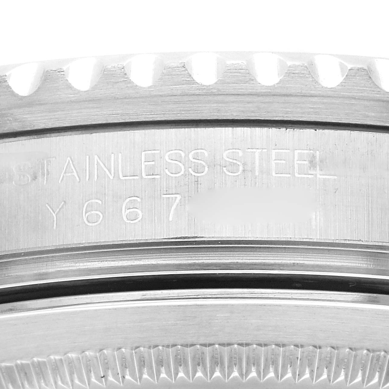 This image shows a close-up of the serial number engraving and part of the bezel of the Rolex GMT-Master 16710 Men's Stainless Steel Black Dial 16710 Men's Stainless Steel Black Dial Stainless Steel model.
