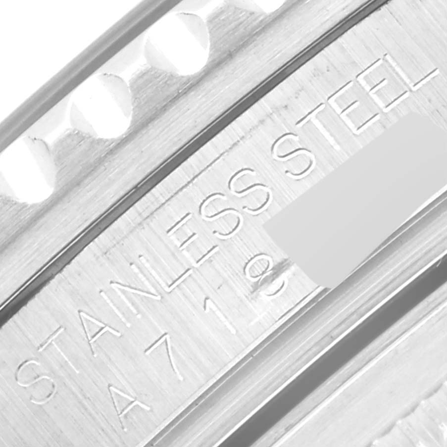 This close-up image shows the edge of the bezel and serial engraving of a Rolex GMT-Master 16710 Men's Stainless Steel Black Dial 16710 Men's Stainless Steel Black Dial, indicating "STAINLESS STEEL".