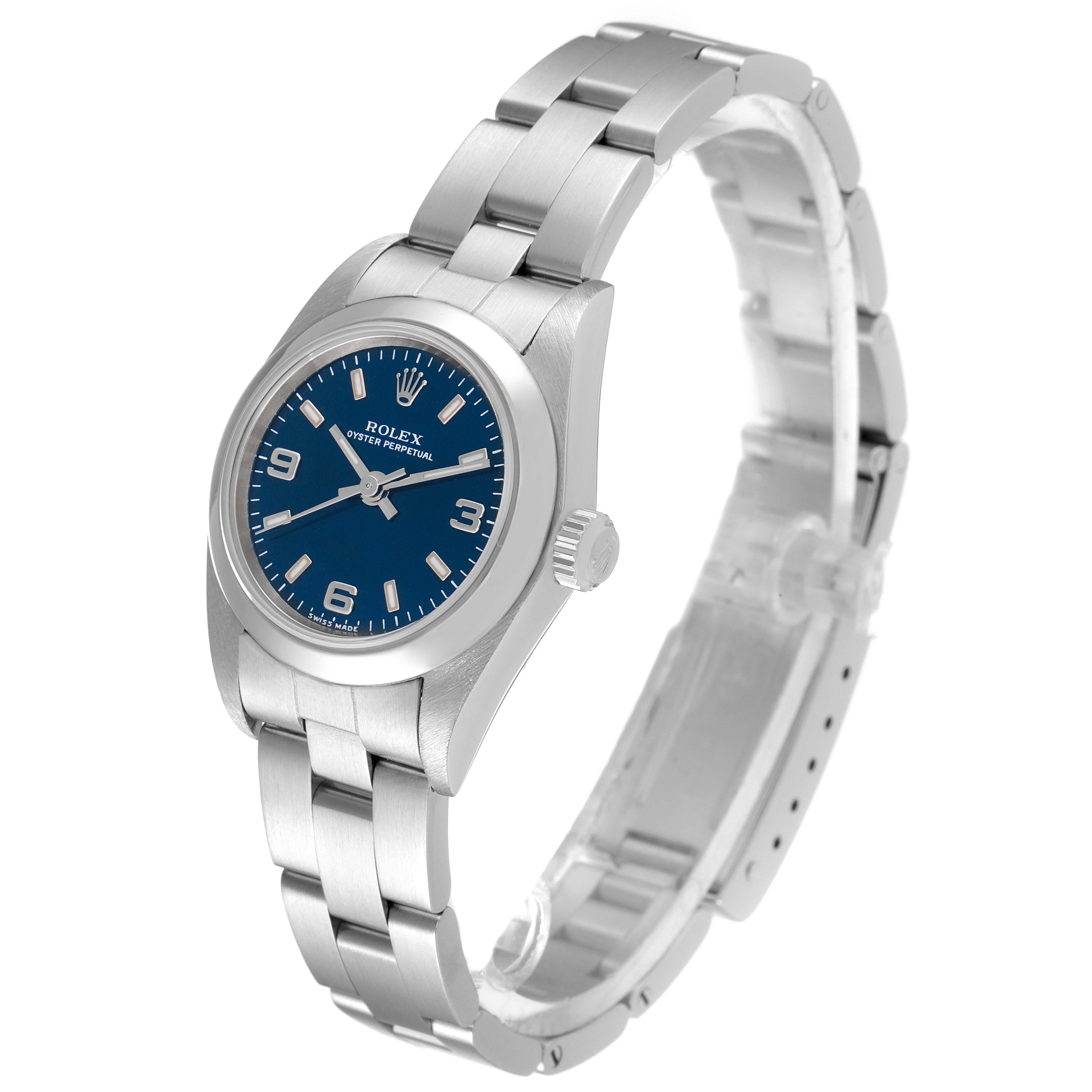 The Rolex Oyster Perpetual 76080 Women's Stainless Steel Blue Dial 76080 Women's Stainless Steel Blue Dial watch is shown at a three-quarter angle, displaying its blue dial, stainless steel case, and bracelet.