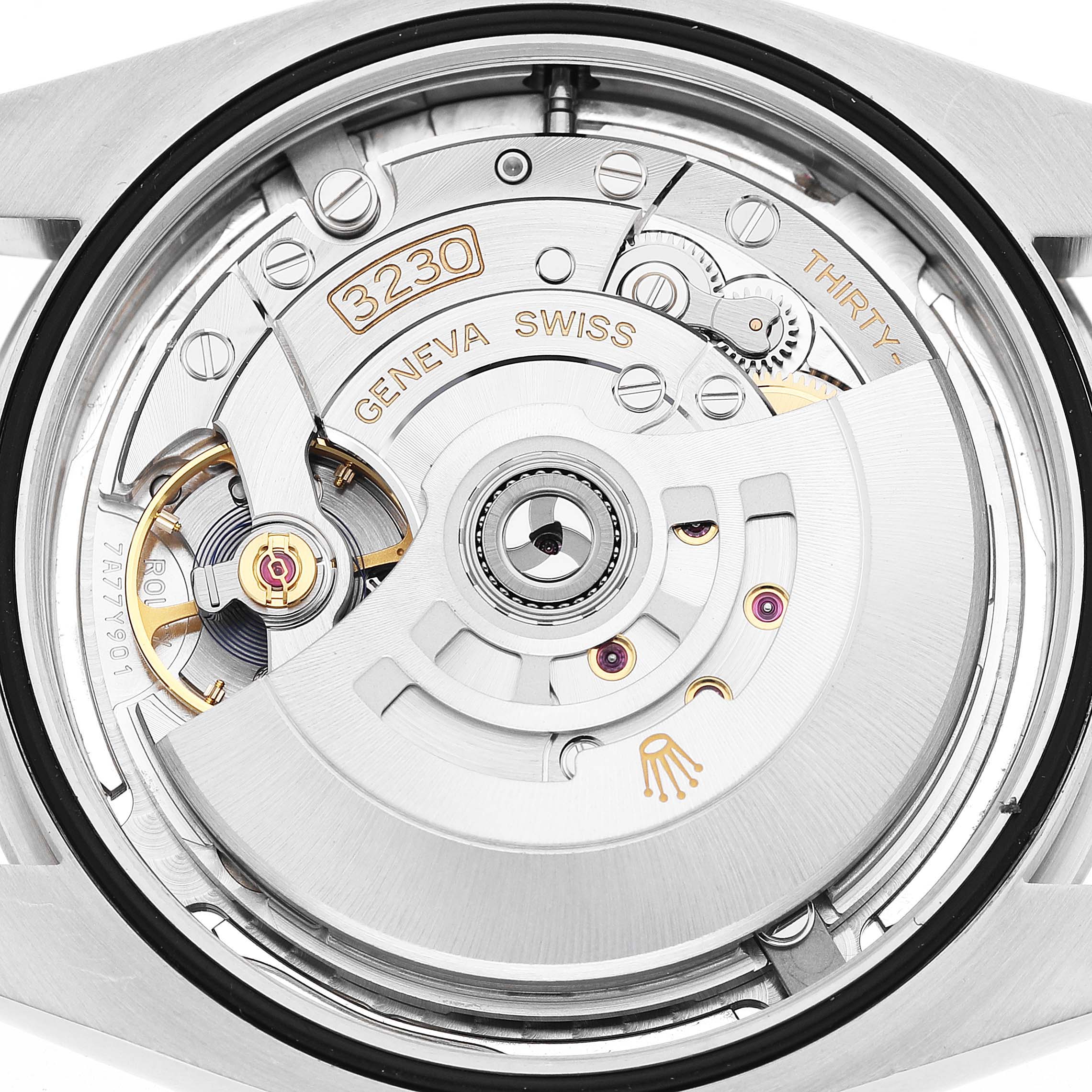The image shows the Rolex Oyster Perpetual 124300 Men's Stainless Steel Silver Dial’s movement assembly from a rear angle, highlighting gears and oscillating weight.