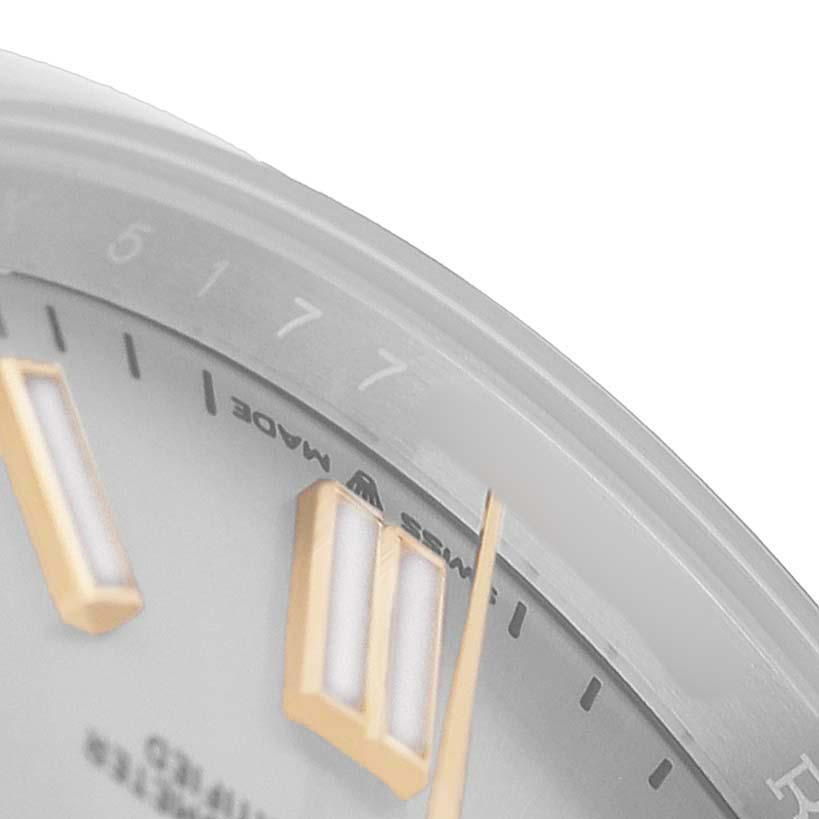 The image shows a close-up of the dial, indices, and bezel edge of the Rolex Oyster Perpetual 124300 Men's Stainless Steel Silver Dial watch.