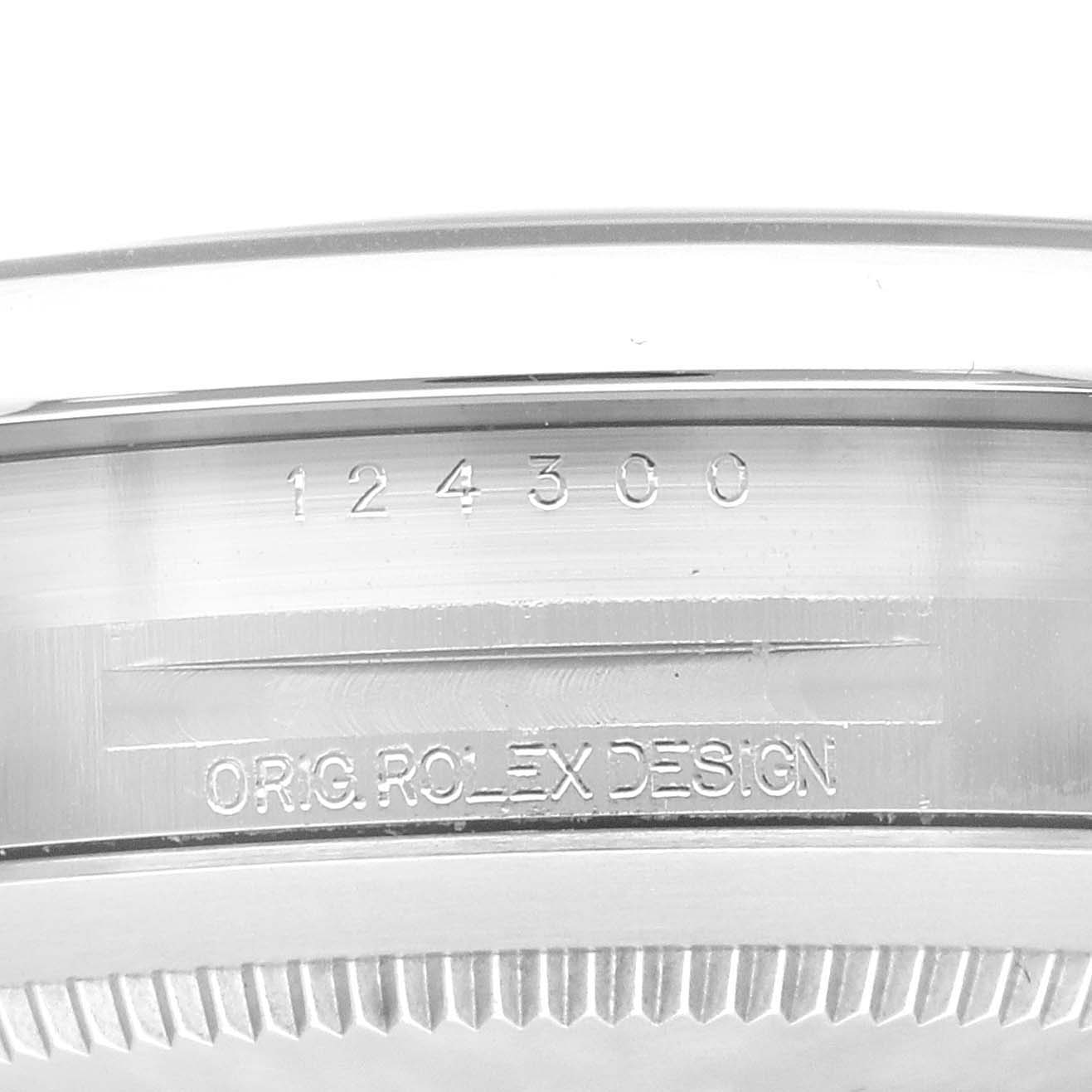 This image shows the side of the case of a Rolex Oyster Perpetual 124300 Men
s Stainless Steel Black Dial 124300 Men
s Stainless Steel Black Dial watch with the engraved model number 124300 and "ORIG. ROLEX DESIGN."