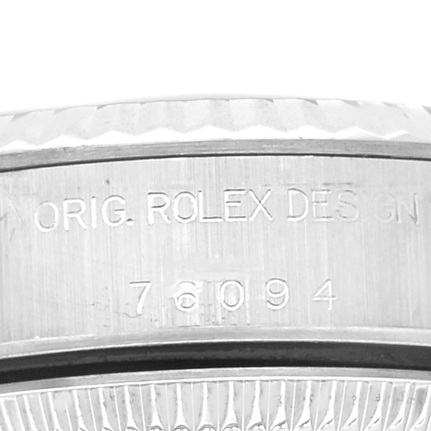 The image shows a close-up view of the bezel and case side of a Rolex Oyster Perpetual 76094 Women
s Stainless Steel Pink Dial 76094 Women
s Stainless Steel Pink Dial watch, highlighting the model number engraving.