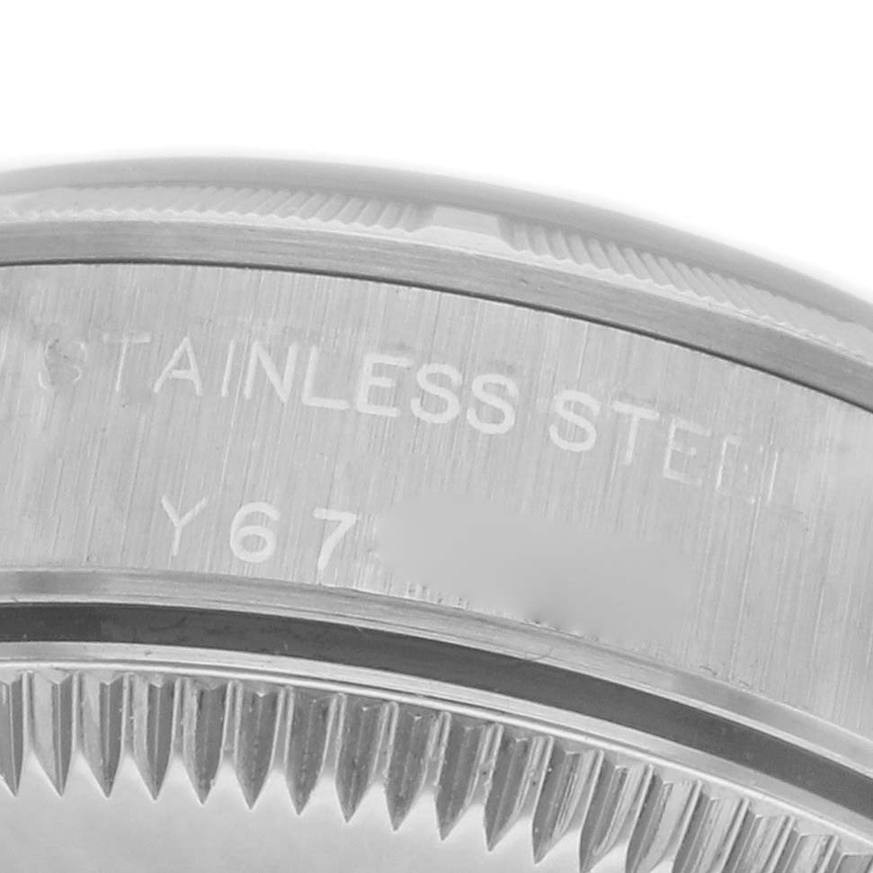 The image shows the side view of a Rolex Oyster Perpetual 76030 Women's Stainless Steel Black Dial 76030 Women's Stainless Steel Black Dial, focusing on the stainless steel engraved bezel edge.