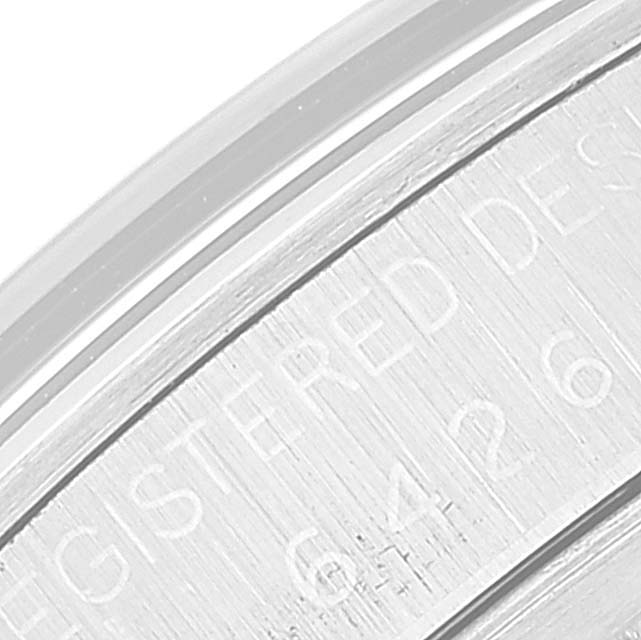 This close-up image of the Rolex Vintage Collection 6426 Men's Stainless Steel Silver Dial 6426 Men's Stainless Steel Silver Dial watch focuses on the engraved side of the case, showing partial serial numbers and text.