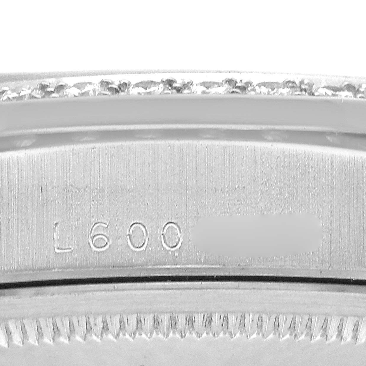The image shows a close-up of the case back edge and part of the bezel of the Rolex President 18346 Men's Platinum Silver Dial 18346 Men's Platinum Silver Dial model, highlighting its serial number engraving.