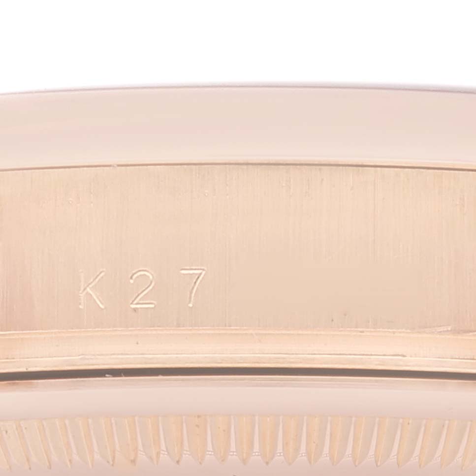 This close-up image shows the engraved case side and part of the bezel of a Rolex President 118205 Men's Rose Gold Mother of Pearl Dial 118205 Men's Rose Gold Mother of Pearl Dial model watch.