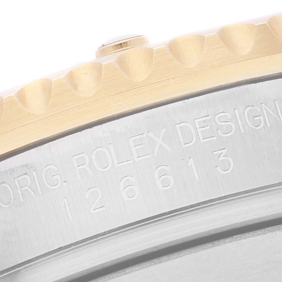 This image shows the side detail of a Rolex Submariner 126613 Men's Steel and Gold (two tone) Black Dial 126613 Men's Steel and Gold (two tone) Black Dial watch, highlighting the bezel and the engraved serial number.