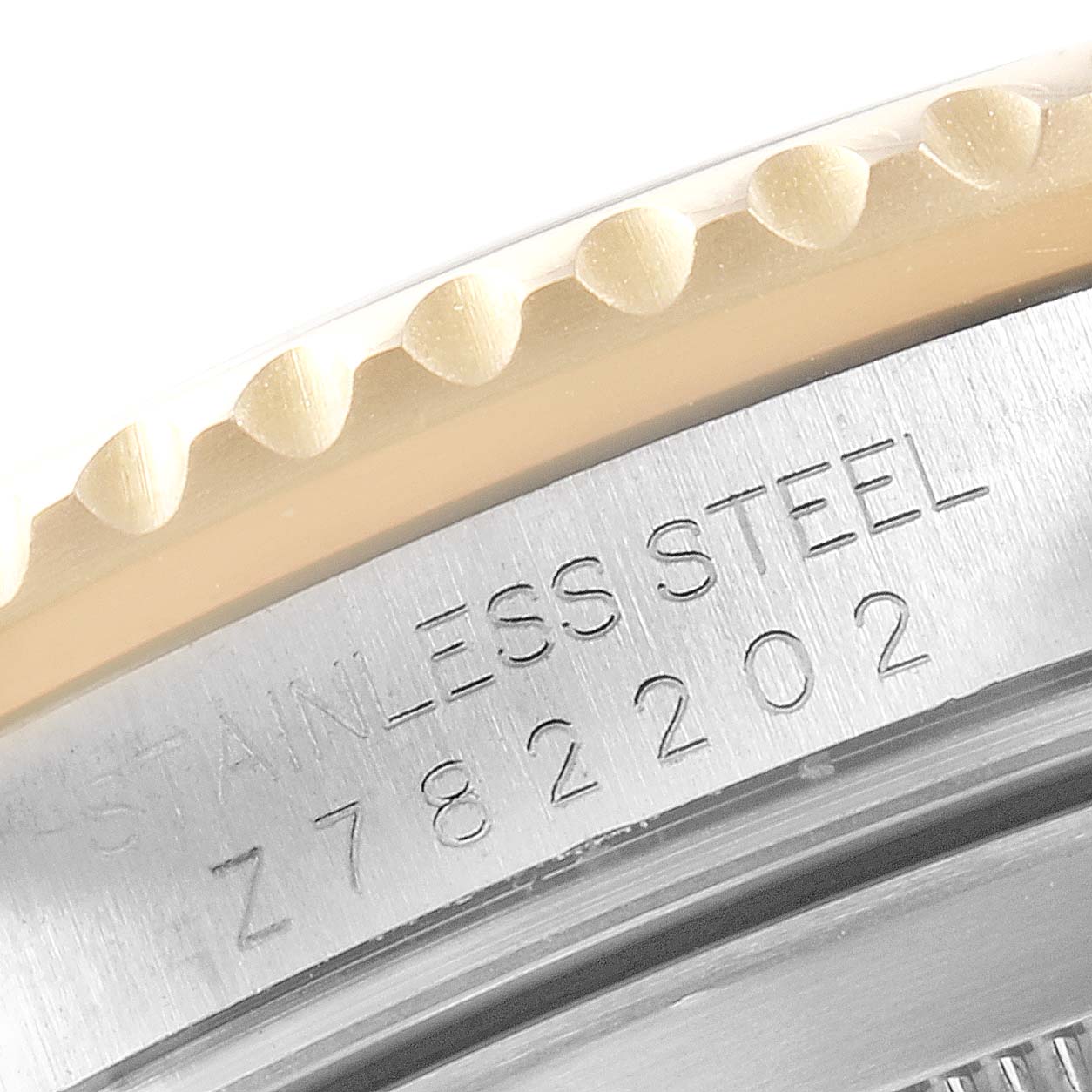 This close-up image shows the serial number engraved on the stainless steel caseback edge of a Rolex Submariner 16613 Men
s Steel and Gold (two tone) Blue Dial 16613 Men
s Steel and Gold (two tone) Blue Dial watch.