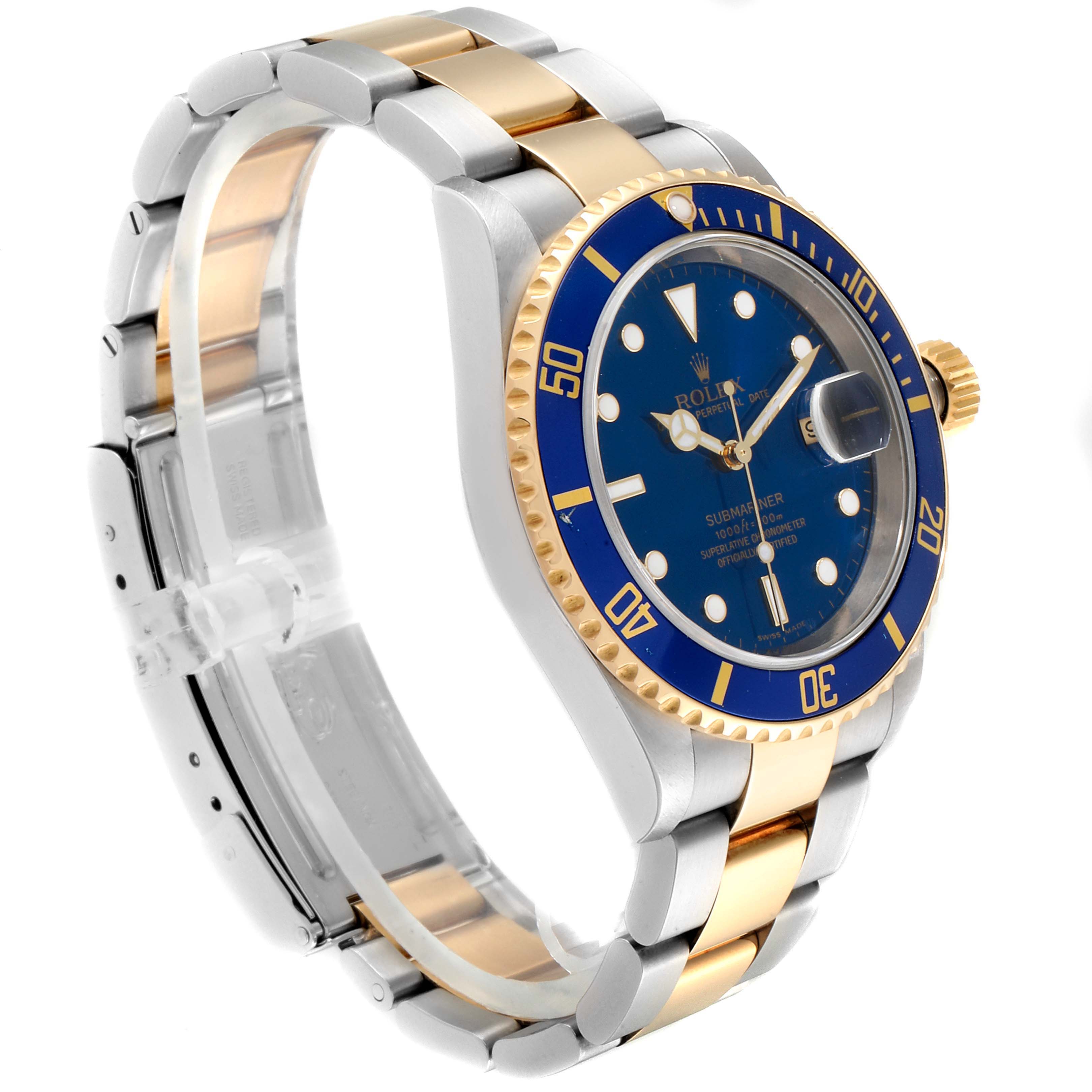 The image shows a side angle of a Rolex Submariner 16613 Men
s Steel and Gold (two tone) Blue Dial 16613 Men
s Steel and Gold (two tone) Blue Dial watch, highlighting its blue dial, gold bezel, and two-tone metal bracelet.