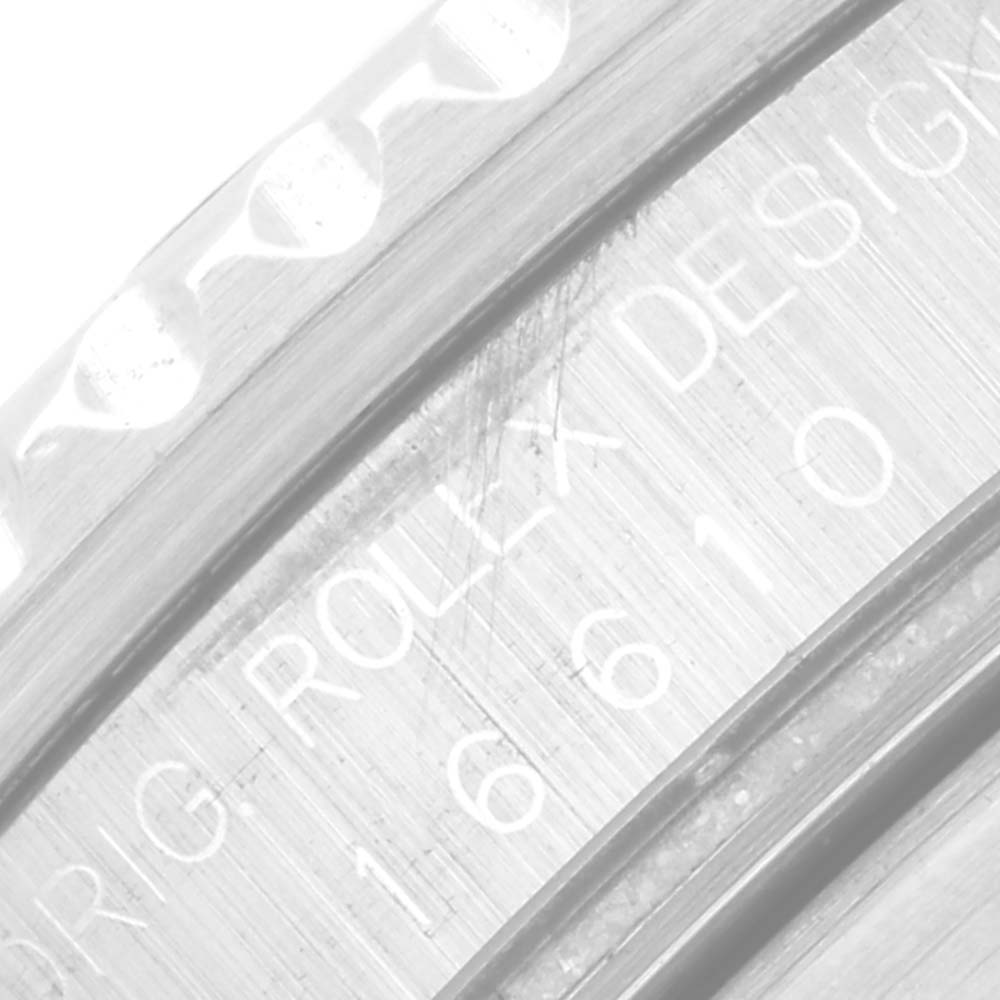 The image shows an angled close-up of the engraved inner bezel of a Rolex Submariner 16610 Men's Stainless Steel Black Dial 16610 Men's Stainless Steel Black Dial watch, displaying part of its model number and brand name.