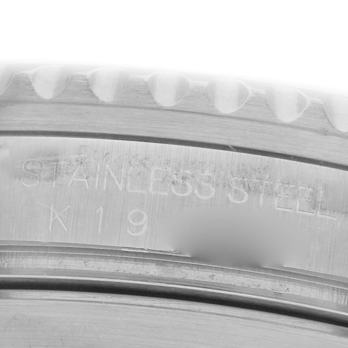 The image shows a close-up of the stainless steel engraving on the Rolex Submariner 16610 Men's Stainless Steel Black Dial 16610 Men's Stainless Steel Black Dial’s inner bezel.
