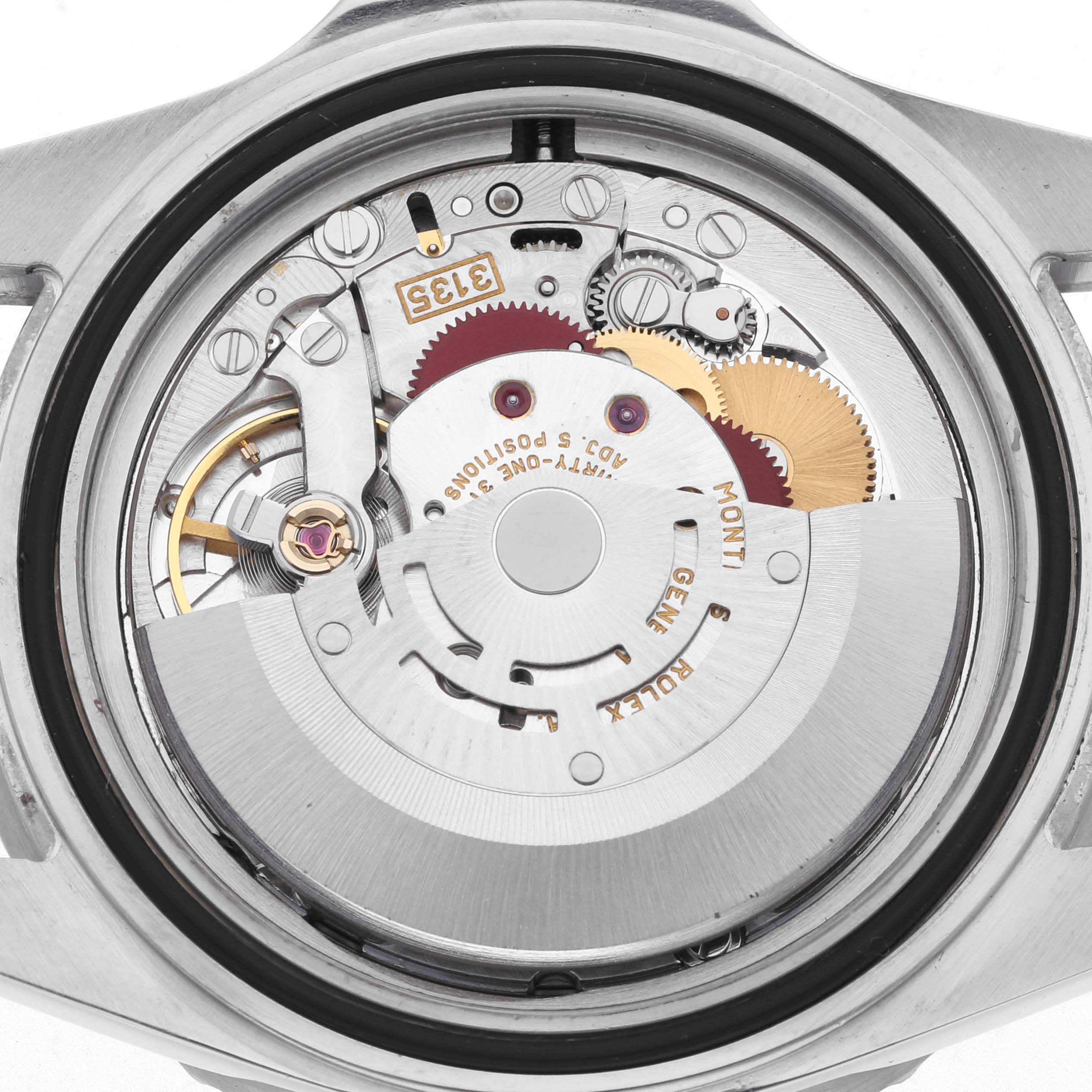 The image shows the back view of a Rolex Submariner 16610 Men's Stainless Steel Black Dial 16610 Men's Stainless Steel Black Dial, highlighting its detailed internal movement parts.