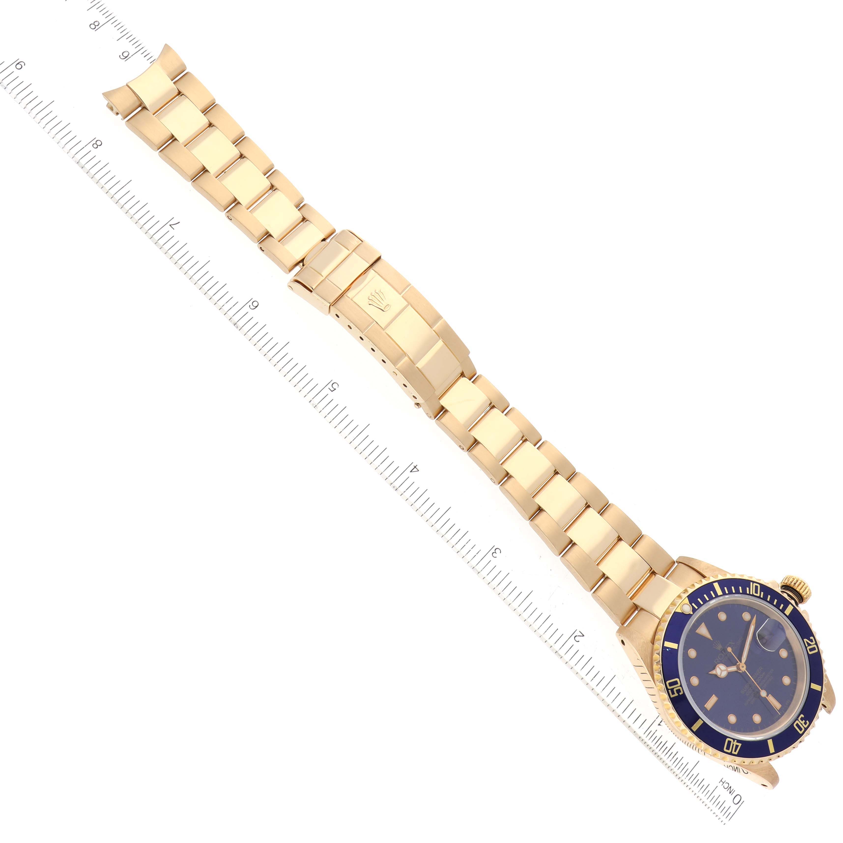 The image shows a top-down view of a Rolex Submariner 16618 Men's Yellow Gold Blue Dial 16618 Men's Yellow Gold Blue Dial watch, highlighting the bracelet and a portion of the bezel and dial.