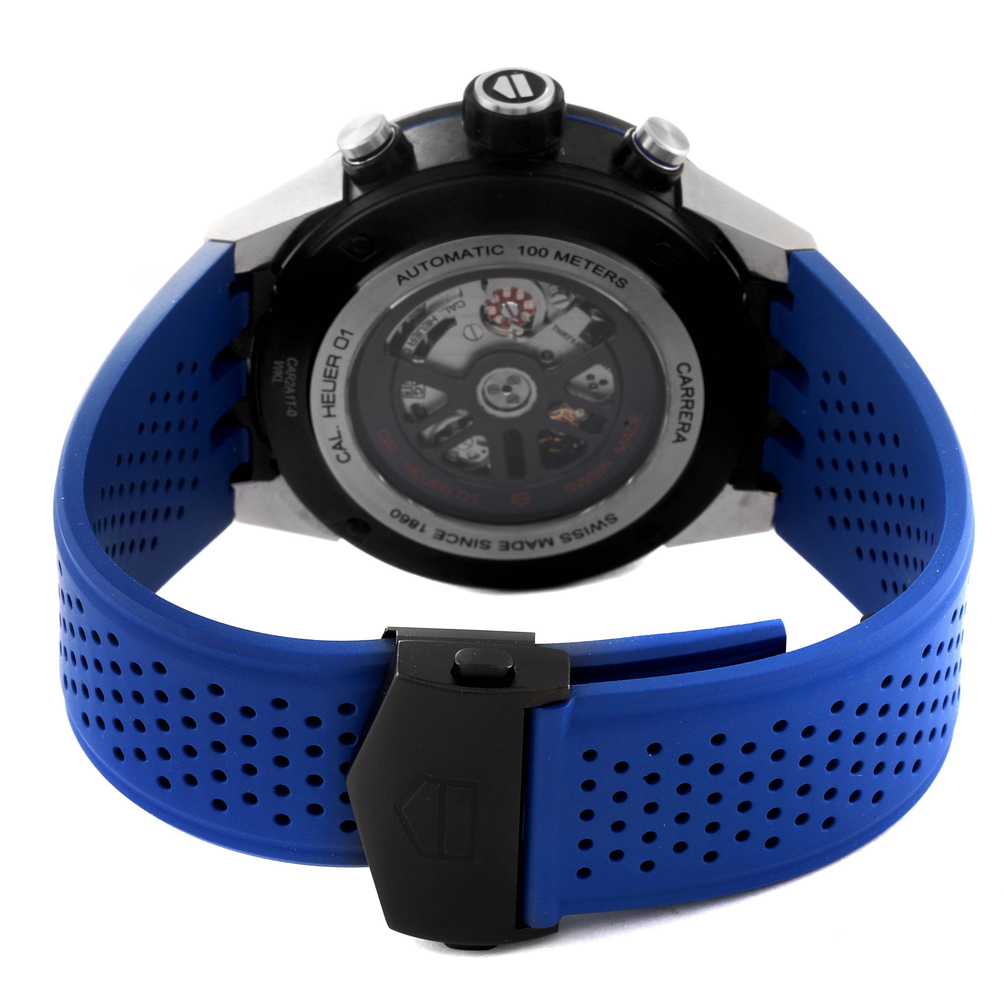The image shows the back view of a Tag Heuer Carrera CAR2A1T Men's Titanium Black Dial CAR2A1T Men's Titanium Black Dial watch with a blue perforated strap and clasp.