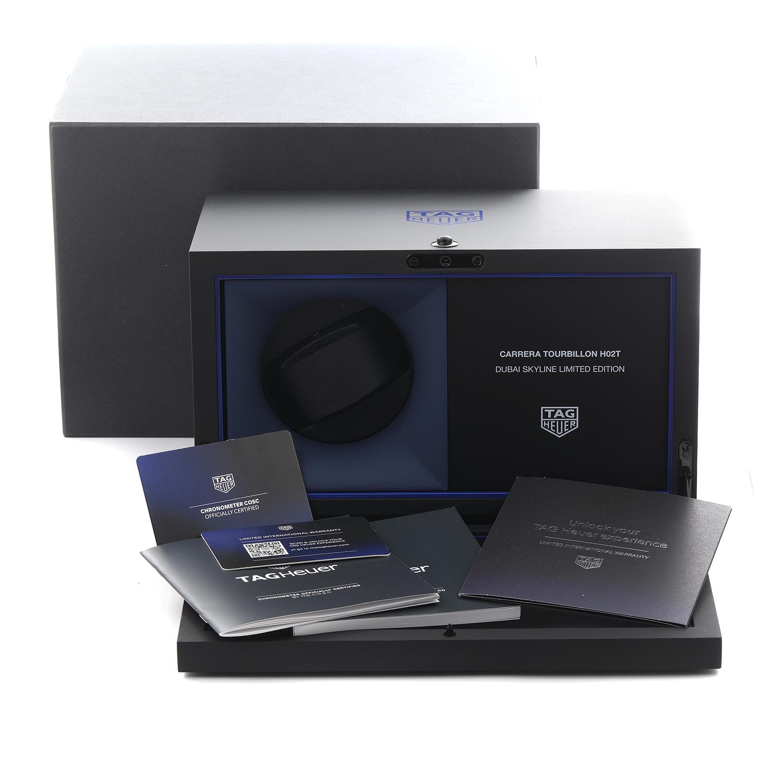 The image shows an open box of the Tag Heuer Carrera CAR5A8AJ.FC6415 Men's Titanium Black Dial CAR5A8AJ.FC6415 Men's Titanium Black Dial model with booklets and a watch holder inside, viewed from the front.