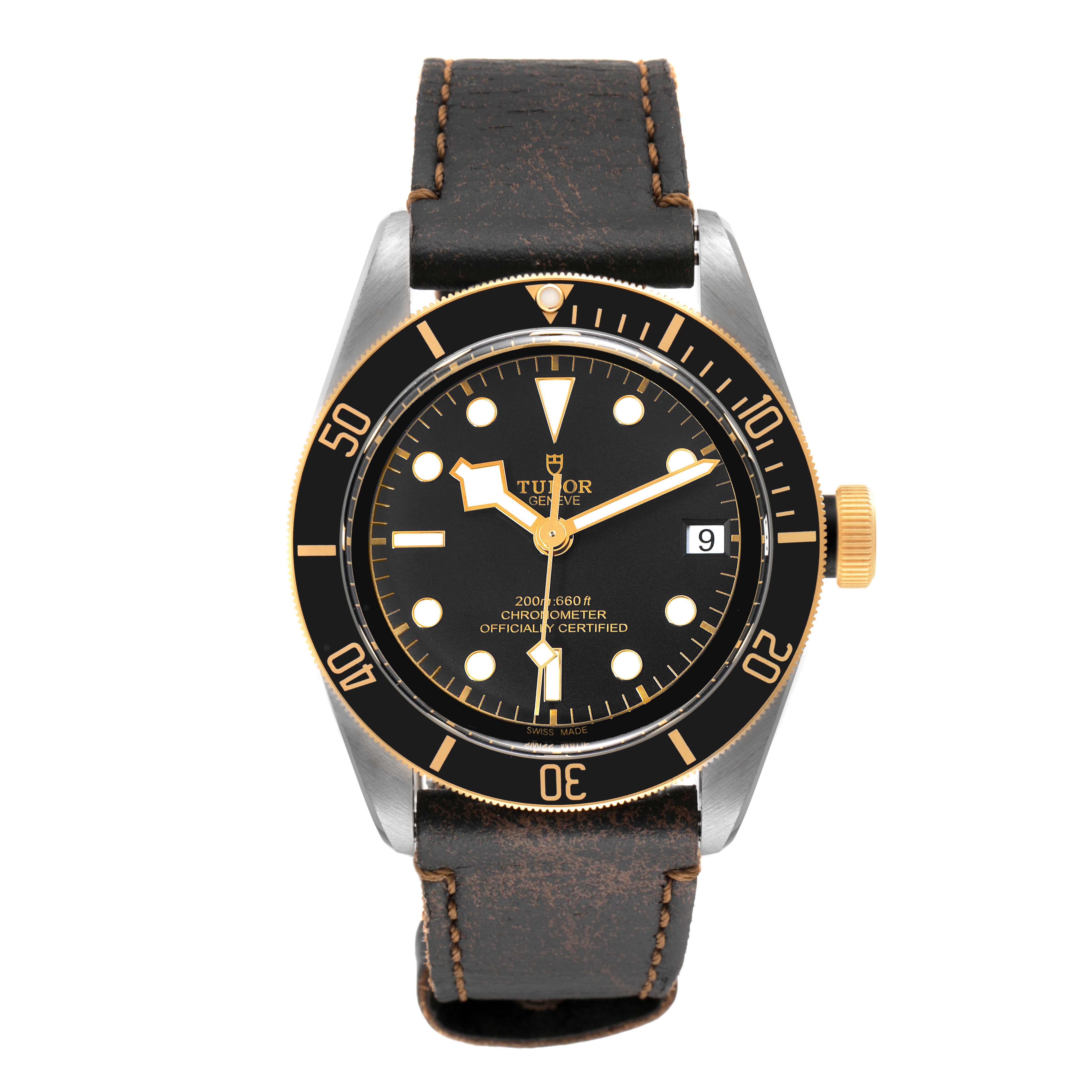 The photo shows the front view of a Tudor Heritage Black Bay 79733N Men's Steel and Gold (two tone) Black Dial 79733N Men's Steel and Gold (two tone) Black Dial watch, highlighting its face, bezel, and leather strap.