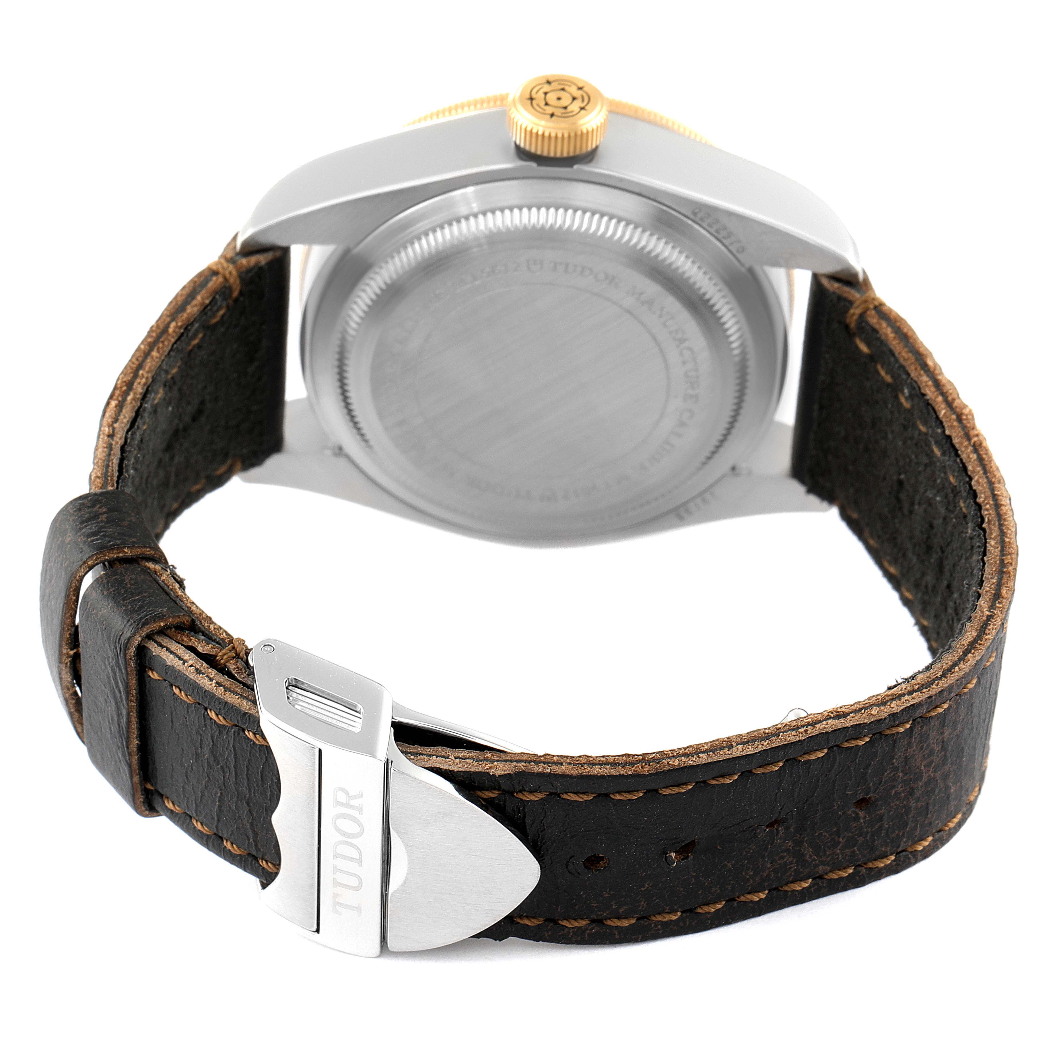 This image shows the back of a Tudor Heritage Black Bay 79733N Men's Steel and Gold (two tone) Black Dial 79733N Men's Steel and Gold (two tone) Black Dial watch, featuring the caseback, crown, and leather strap with buckle.
