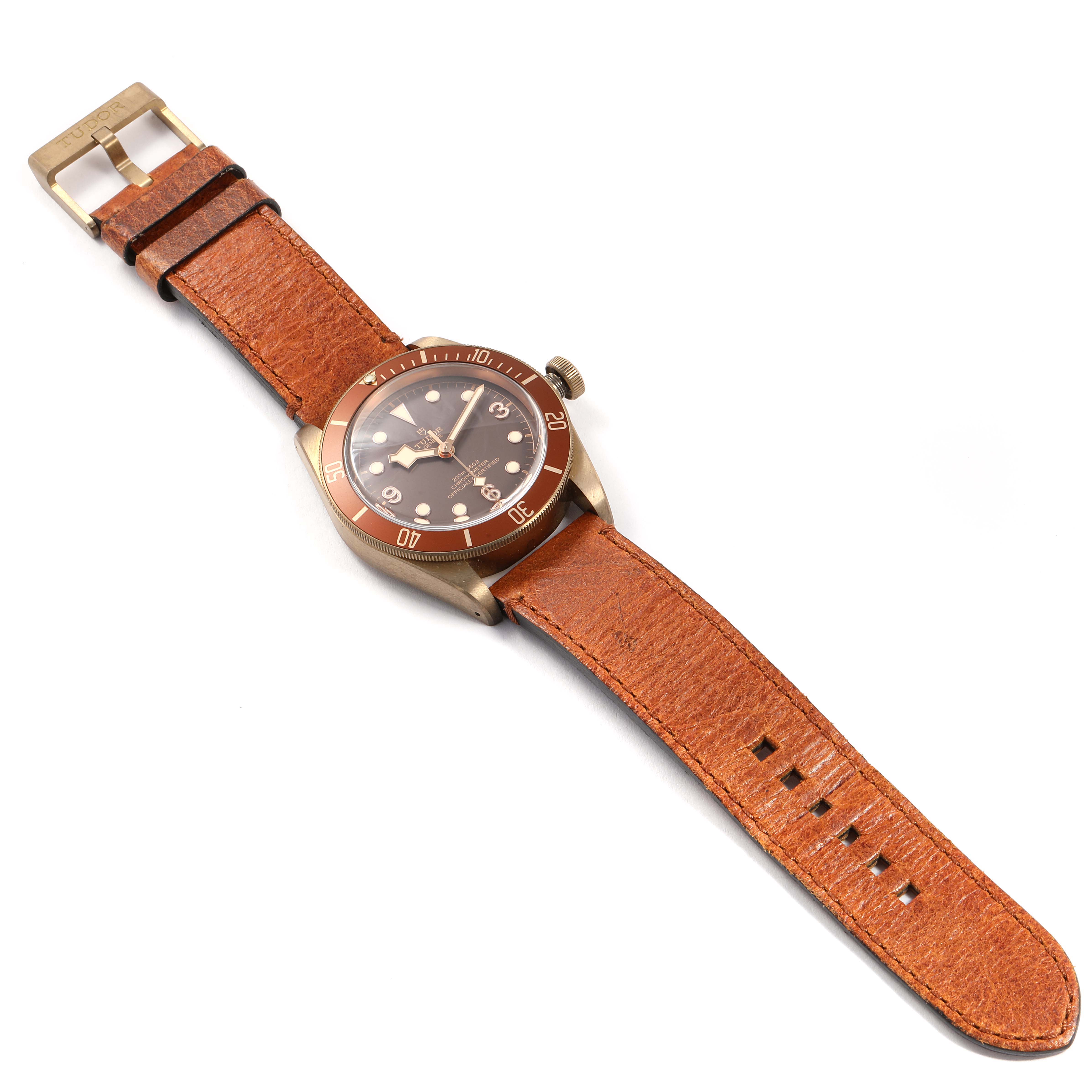 The watch is shown from an overhead angle, displaying the Tudor Heritage Black Bay 79250B Men
s Bronze Brown Dial 79250B Men
s Bronze Brown Dial
s face, bezel, crown, and leather strap.