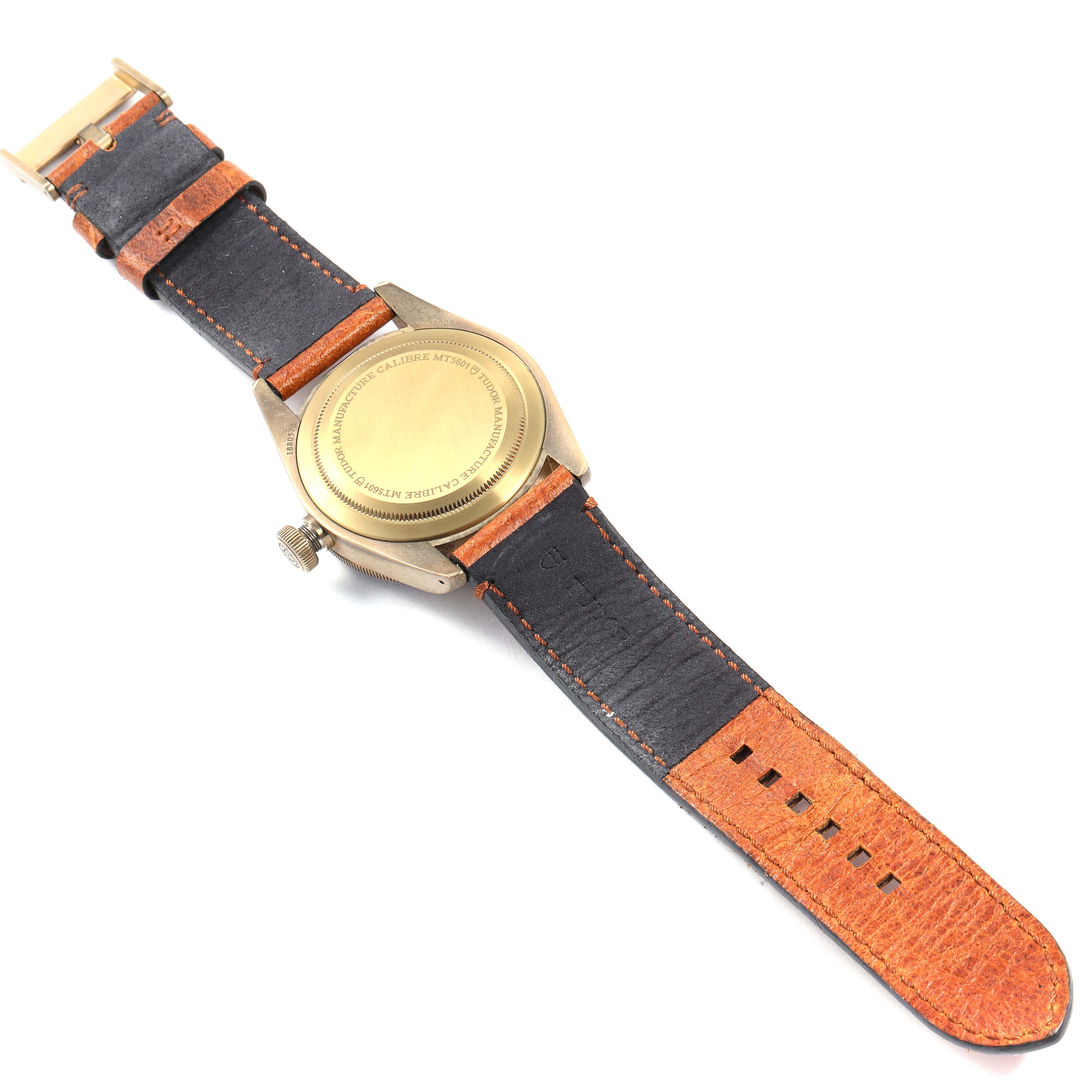 This image shows the Tudor Heritage Black Bay 79250B Men
s Bronze Brown Dial 79250B Men
s Bronze Brown Dial watch from the back, displaying its case back and leather strap.