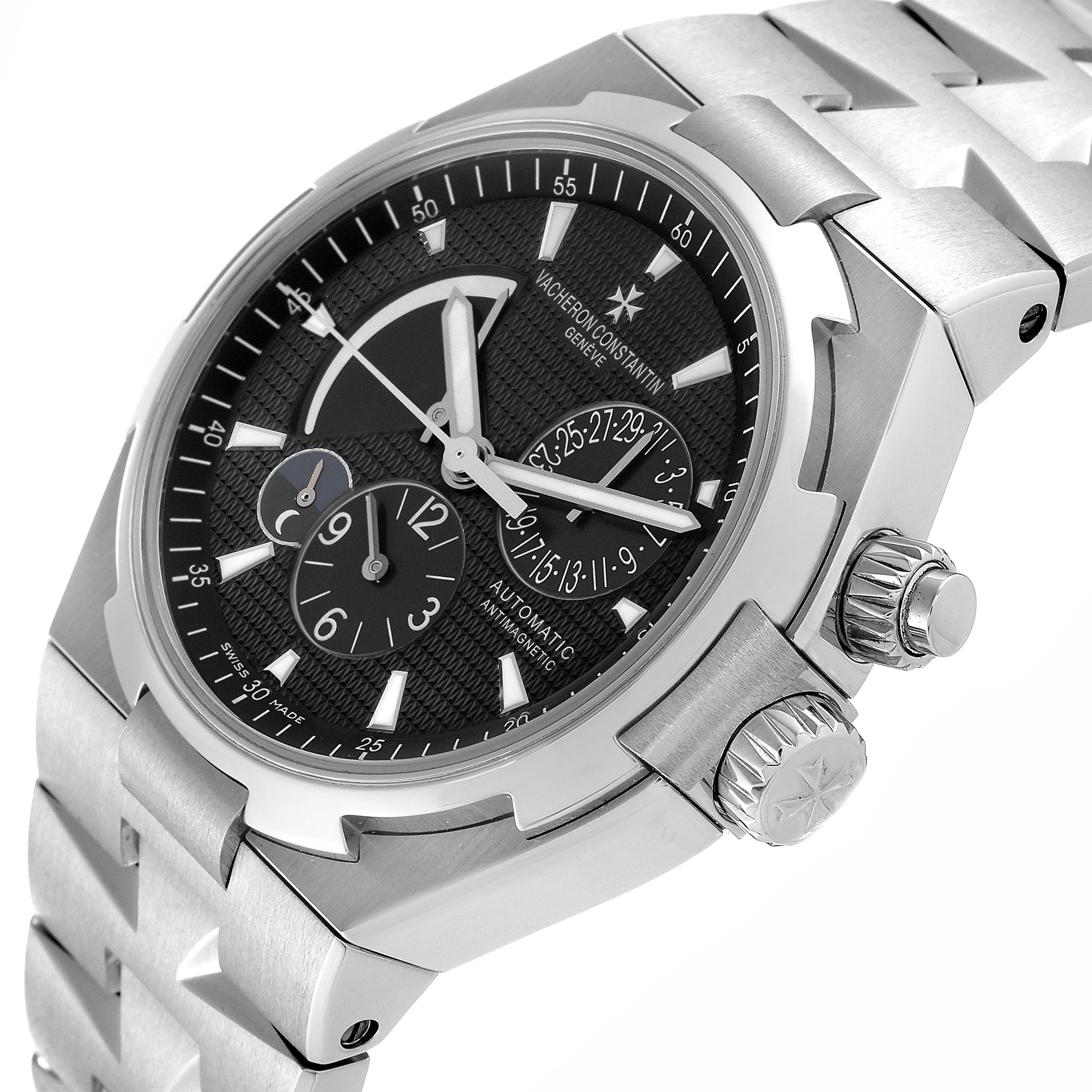 The image shows a Vacheron Constantin Overseas 47450/B01A-9227 Men's Stainless Steel Black Dial 47450/B01A-9227 Men's Stainless Steel Black Dial watch at an angle, highlighting its dial, bezel, crown, and part of the bracelet.
