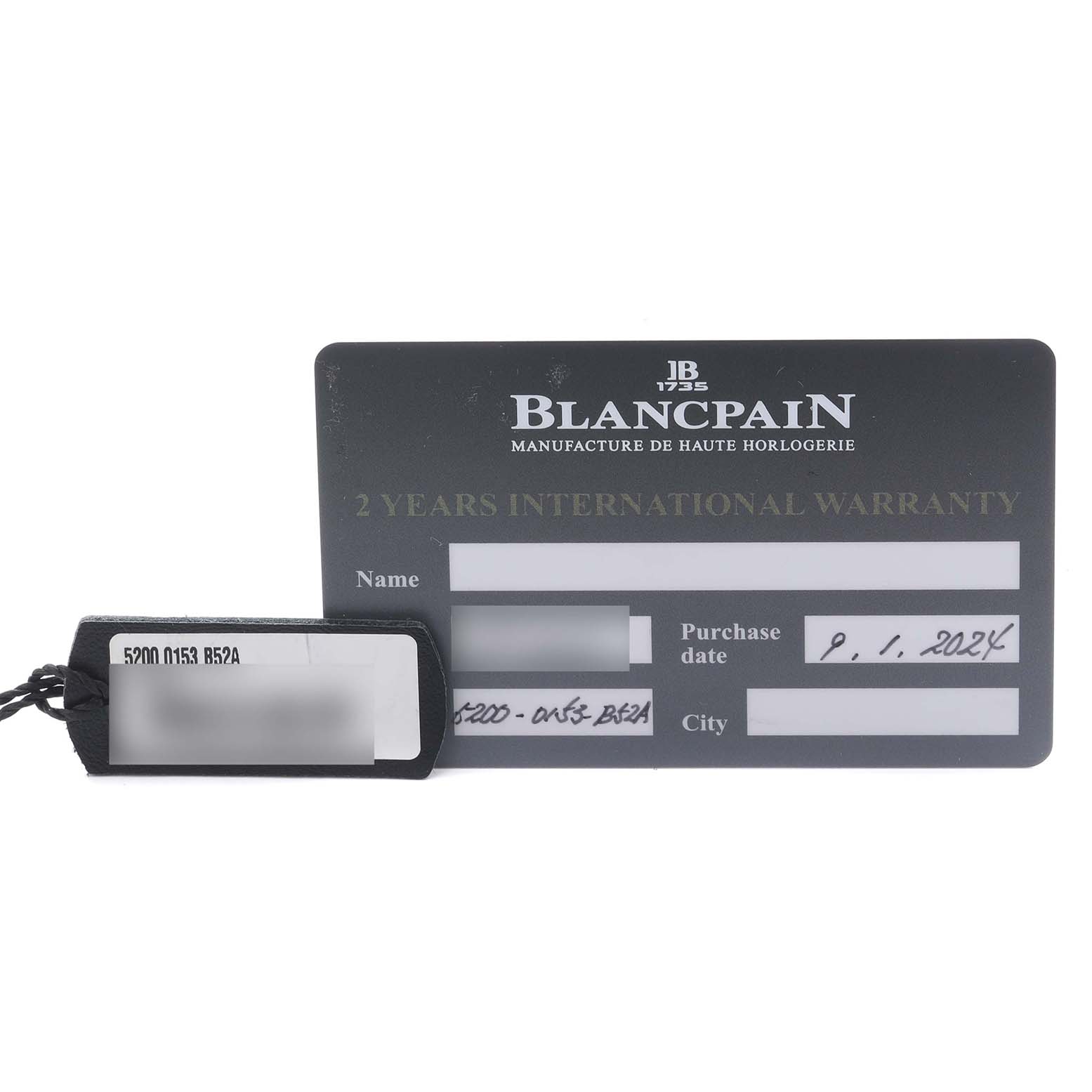 The image shows a Blancpain Fifty Fathoms 5200-0153-B52A Men's Ceramic Green Dial 5200-0153-B52A Men's Ceramic Green Dial warranty card and a tag with model details, viewed from above.