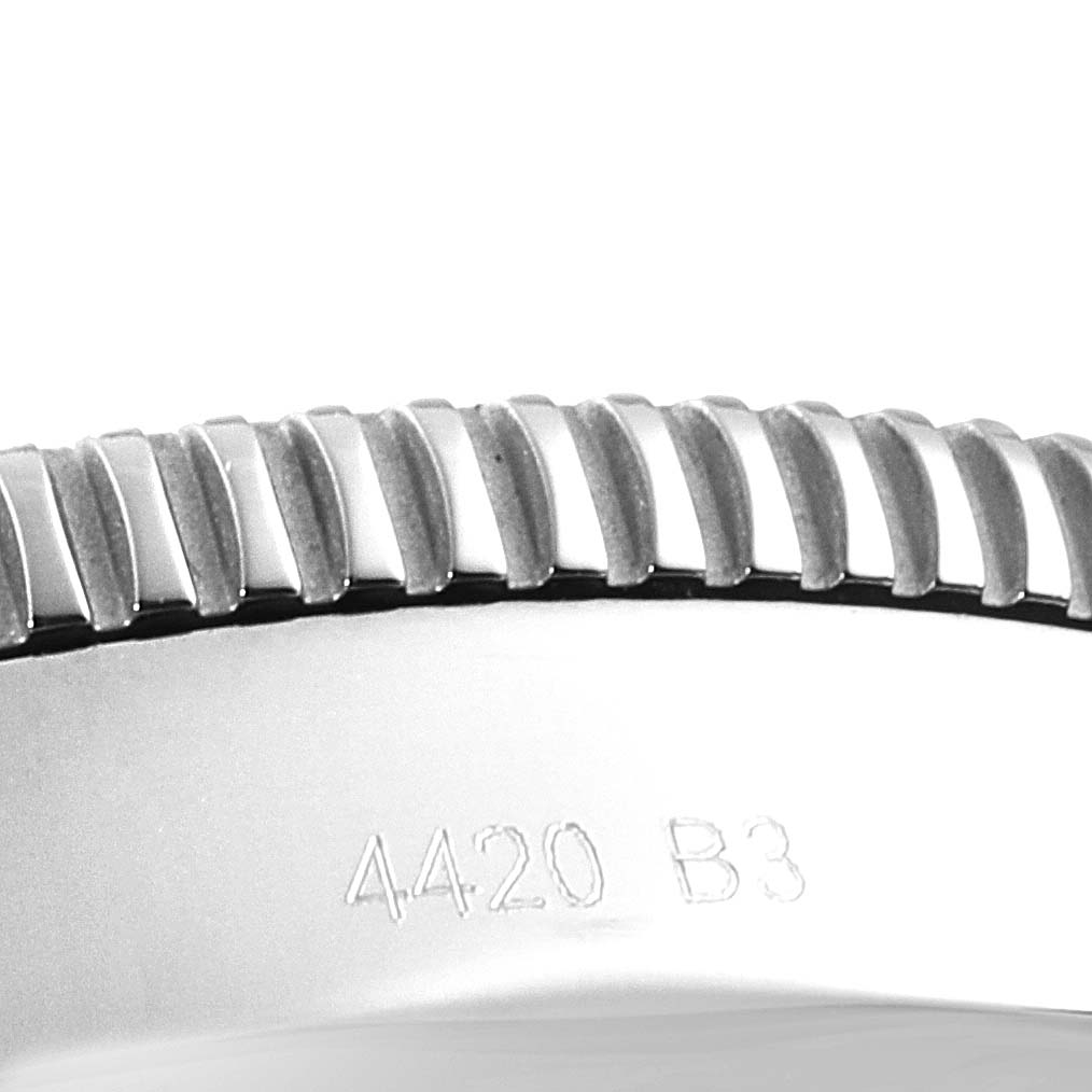 The image shows a close-up of the bezel of a Breitling Superocean AB2020 Men's Stainless Steel Blue Dial AB2020 Men's Stainless Steel Blue Dial watch with part of its serial number engraved.